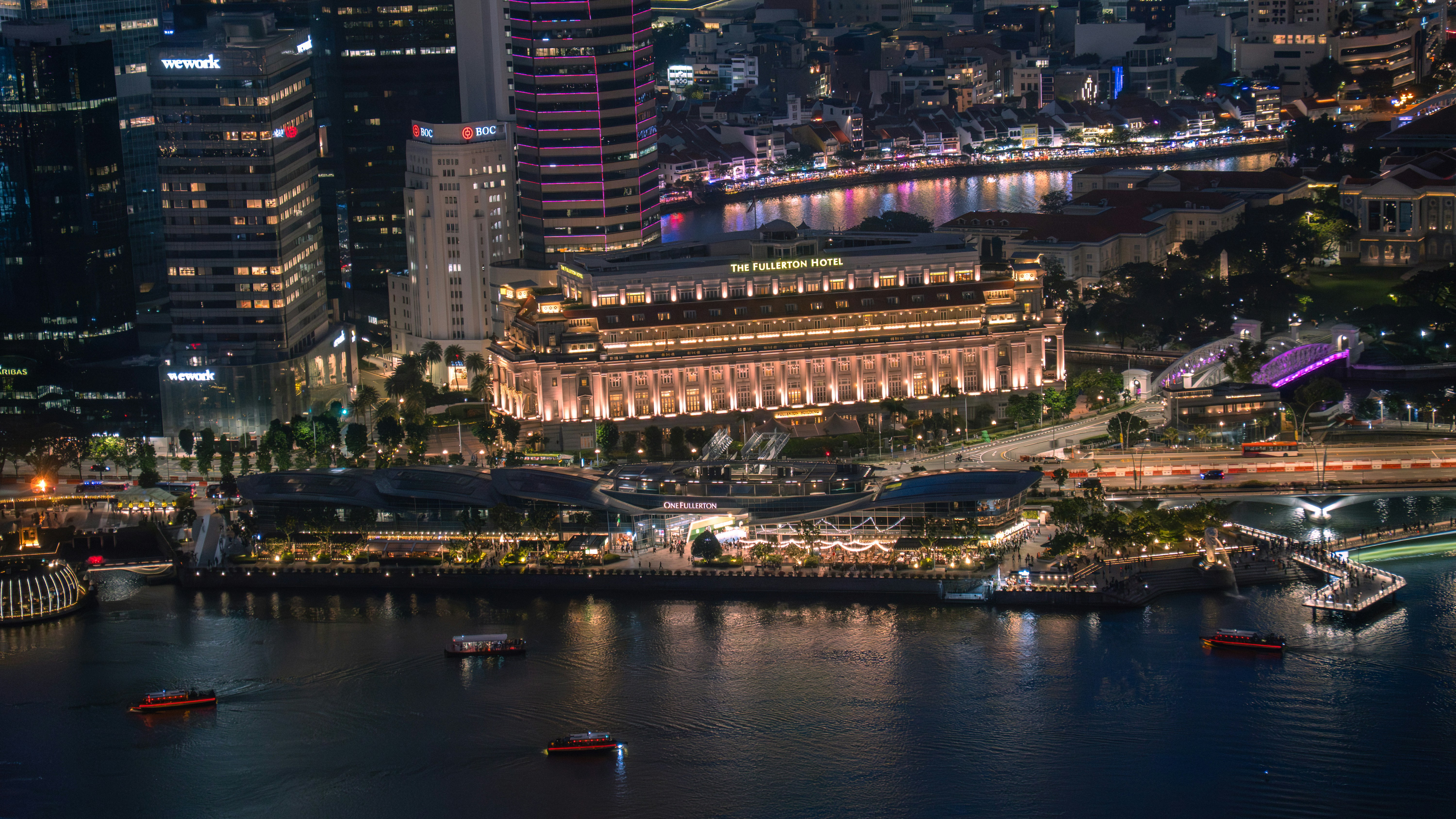 Vibrant cityscape at night with a grand illuminated building.