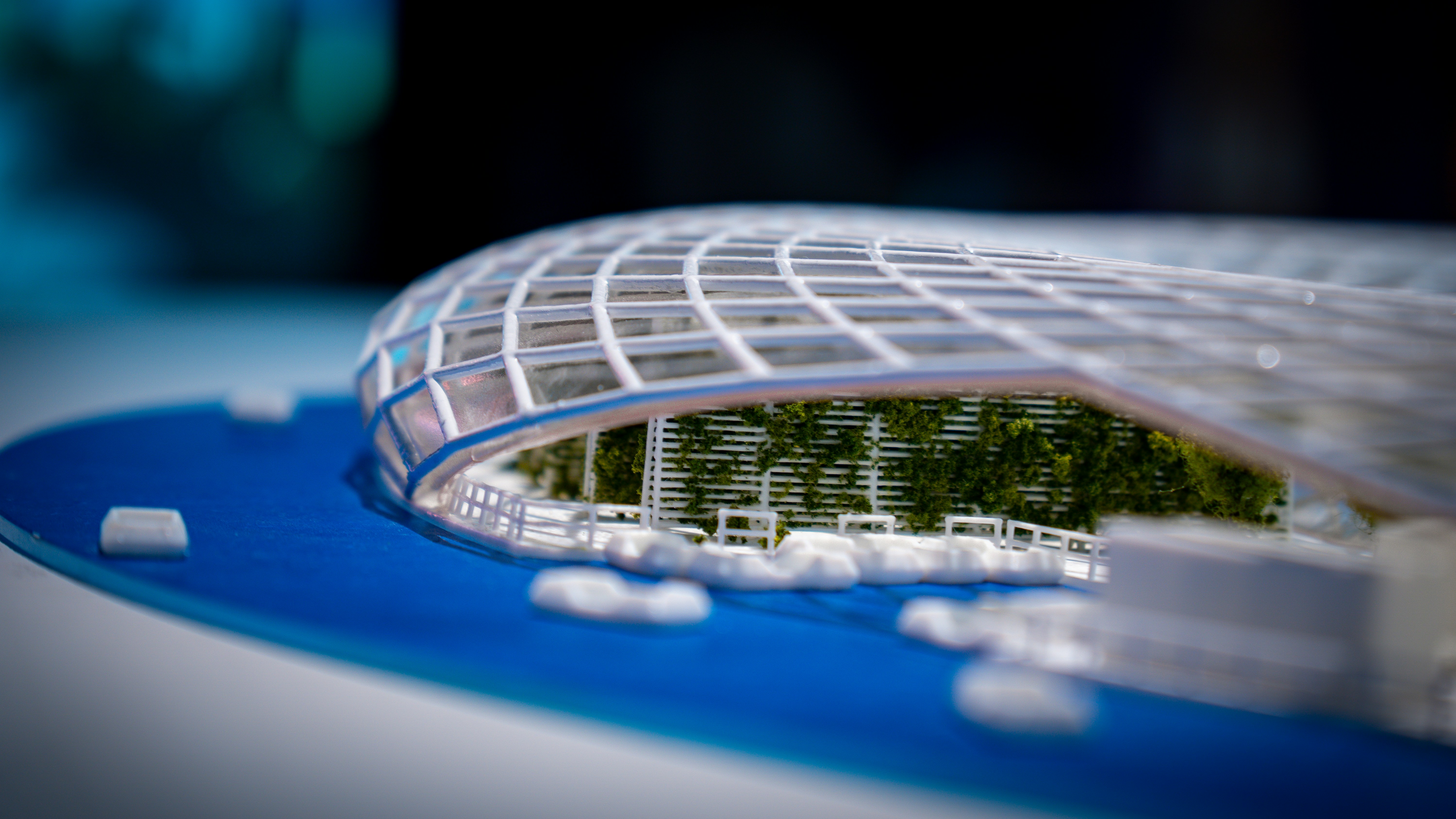 Detailed architectural model featuring a curved, grid-like roof