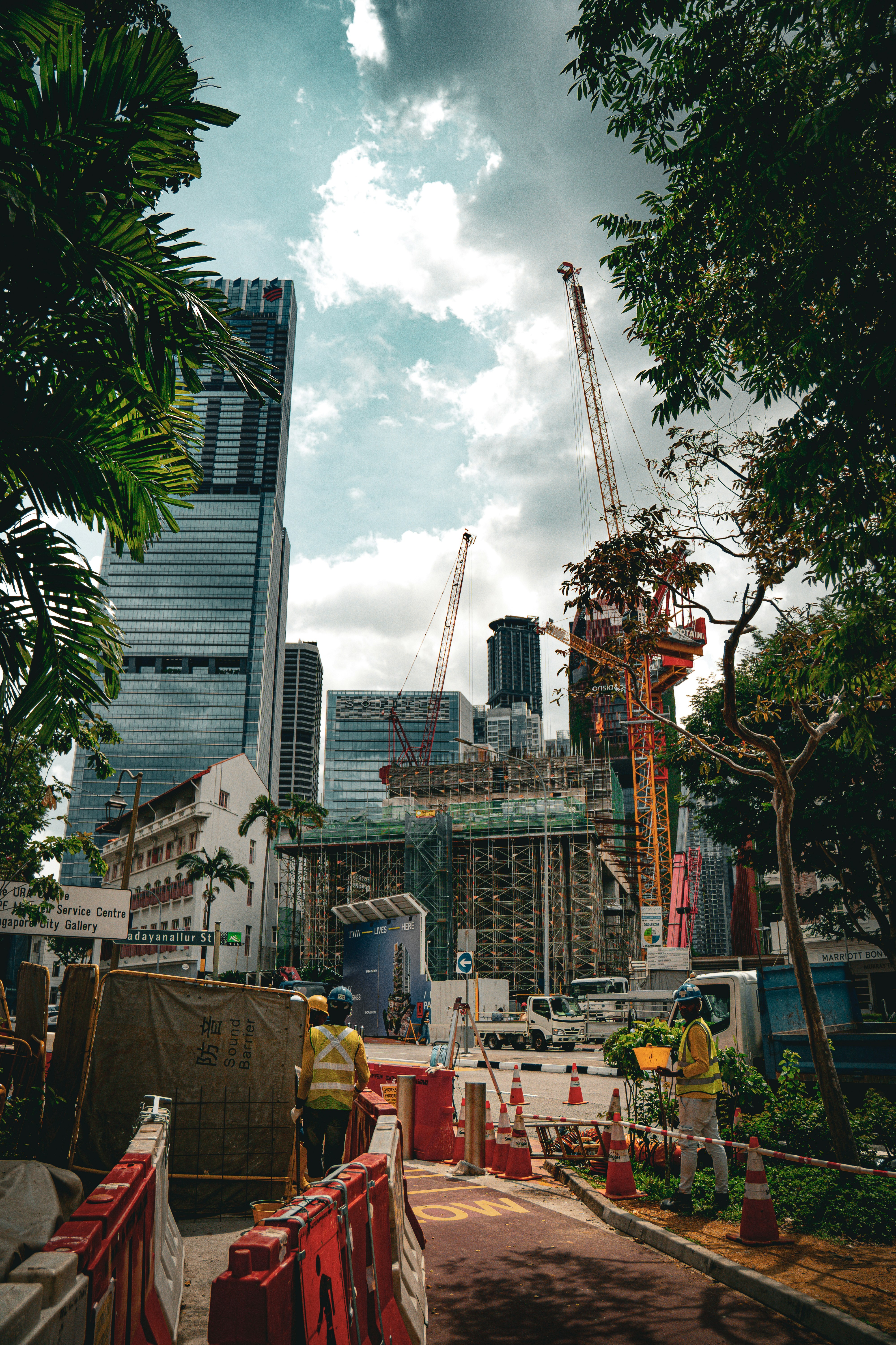 Workers and cranes at a city construction site