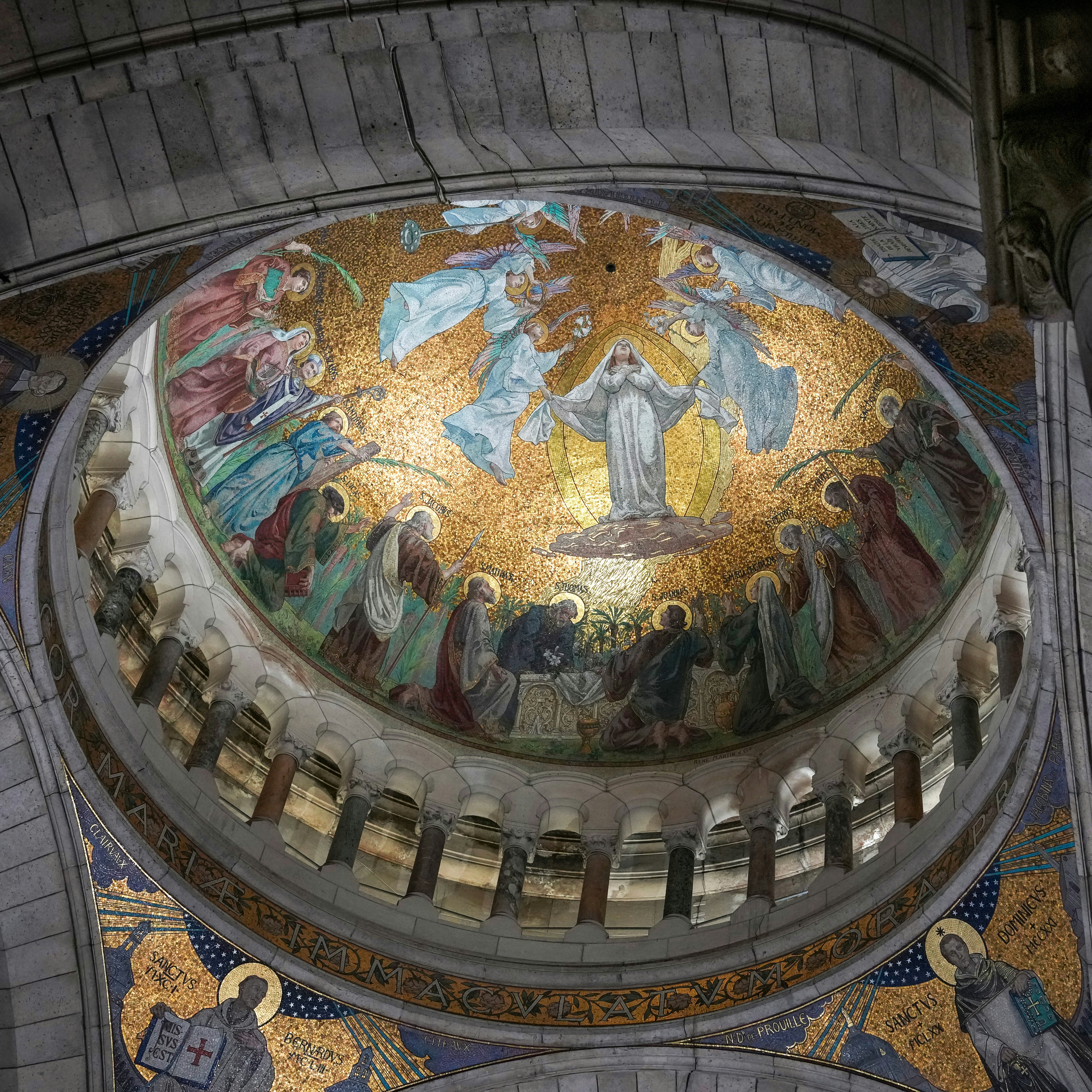 Golden mosaic depicting religious figures inside a church dome.