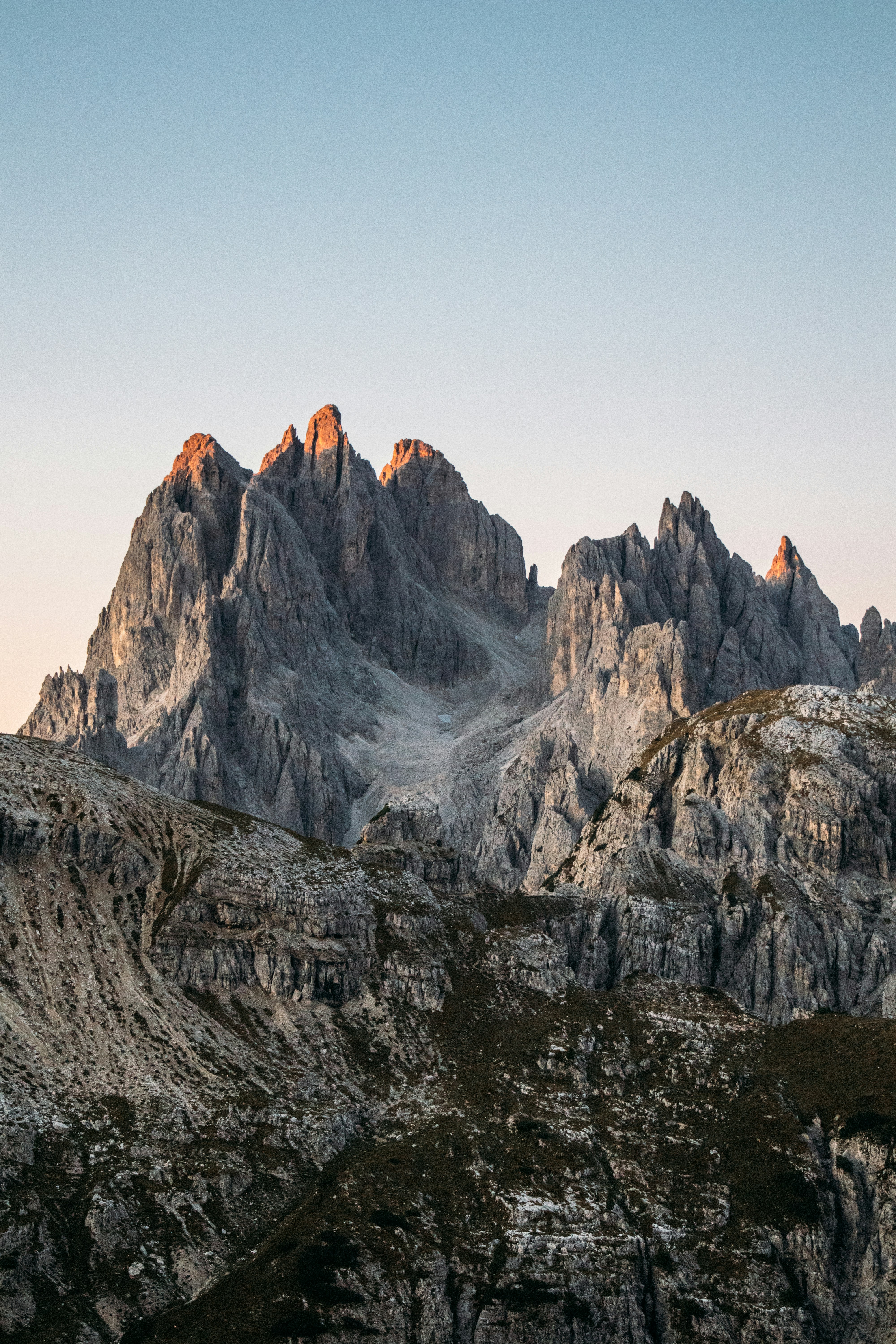 Rocky mountain peaks illuminated by golden sunset light.