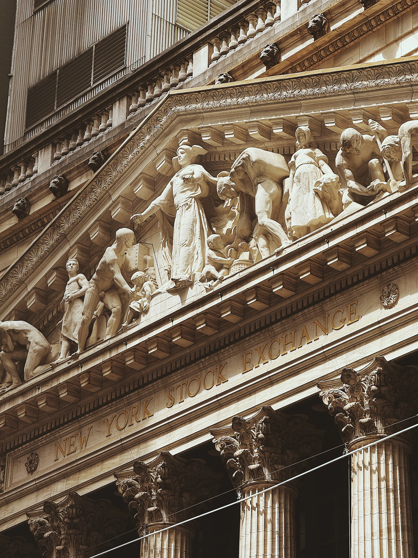 The New York Stock Exchange building facade with sculptures and columns