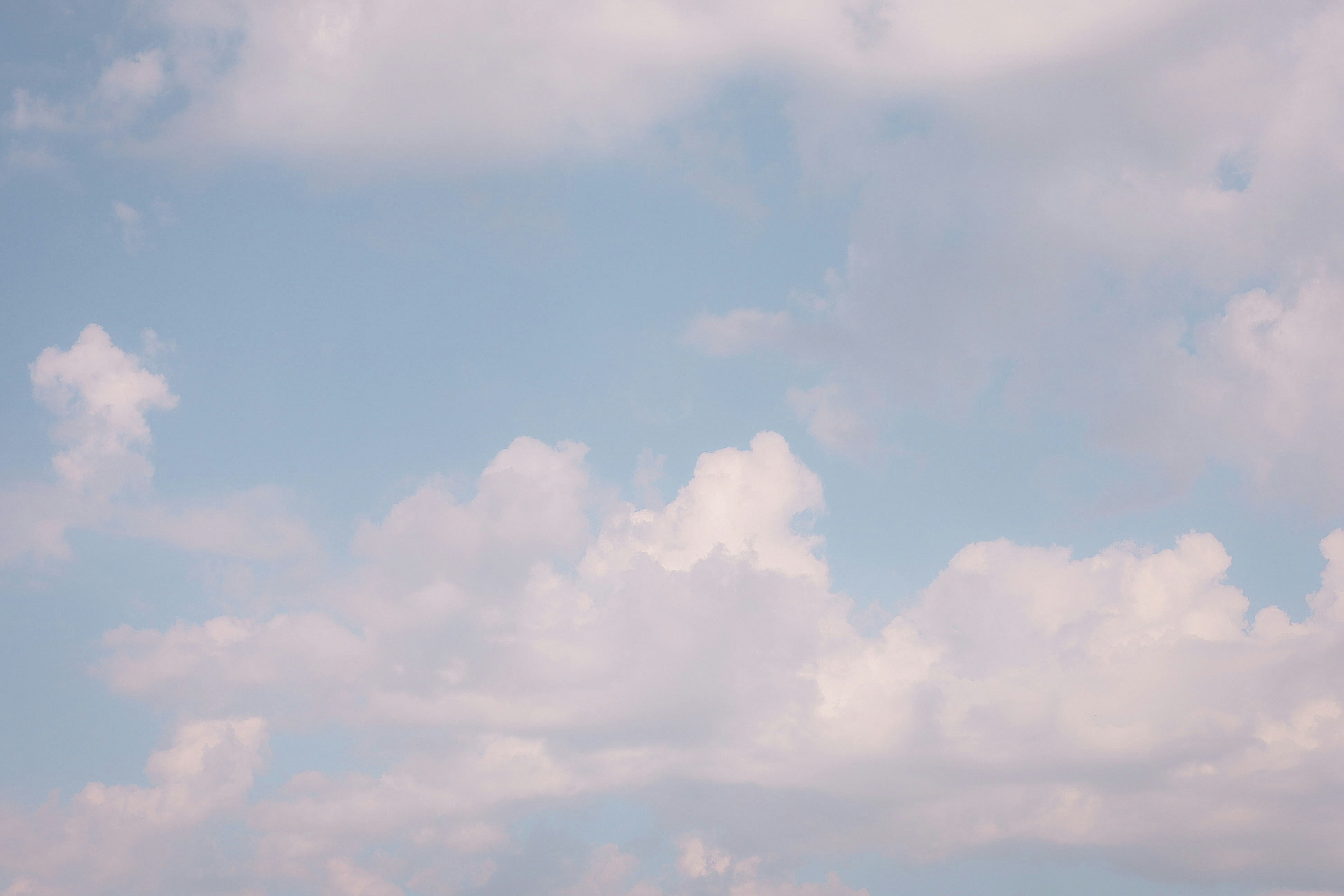 White fluffy clouds scattered across a blue sky