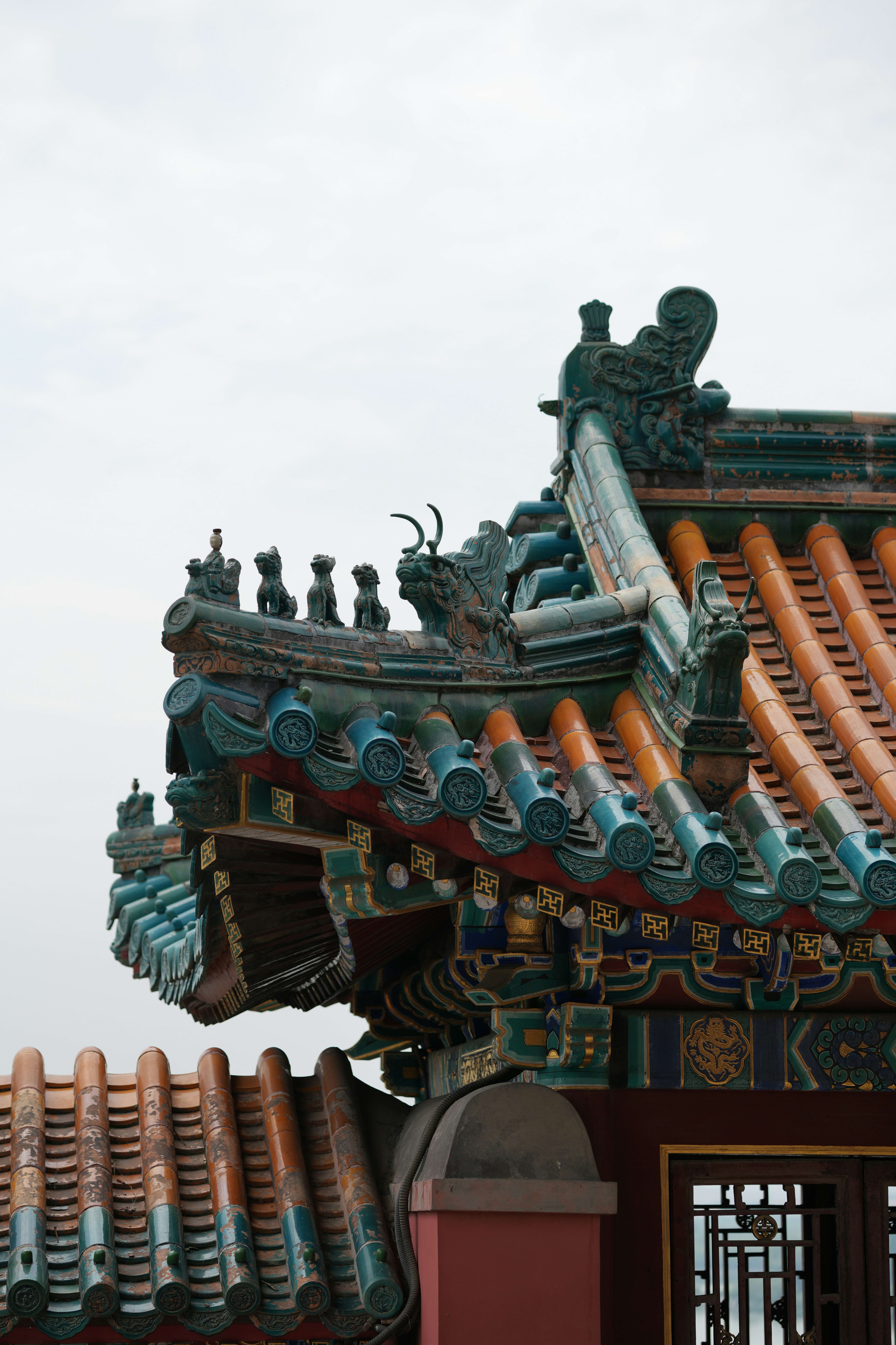 Ornate traditional chinese temple roof with colorful tiles and sculptures.