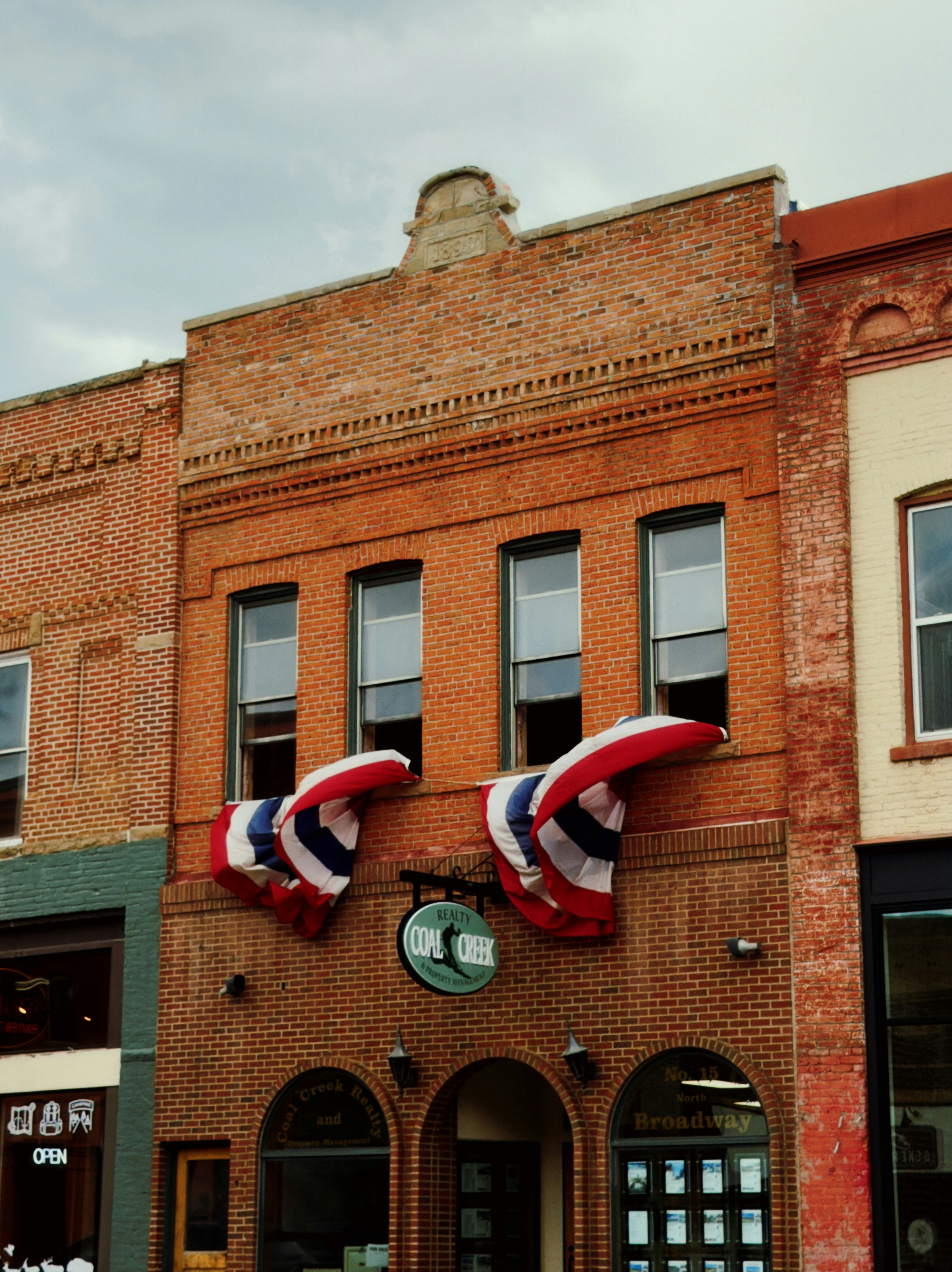 Old brick building decorated with american flag buntings.