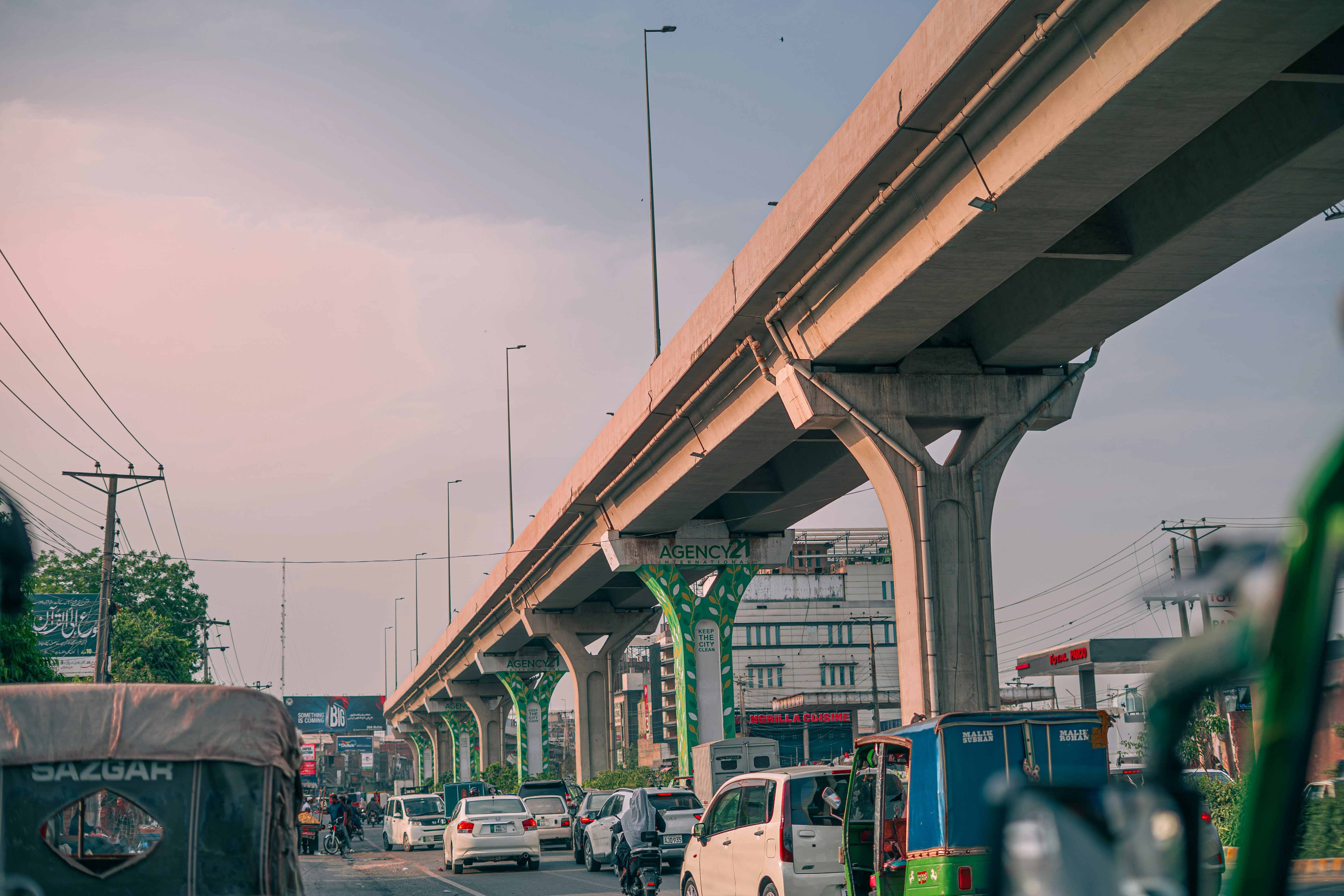 Elevated highway over a busy urban street with traffic
