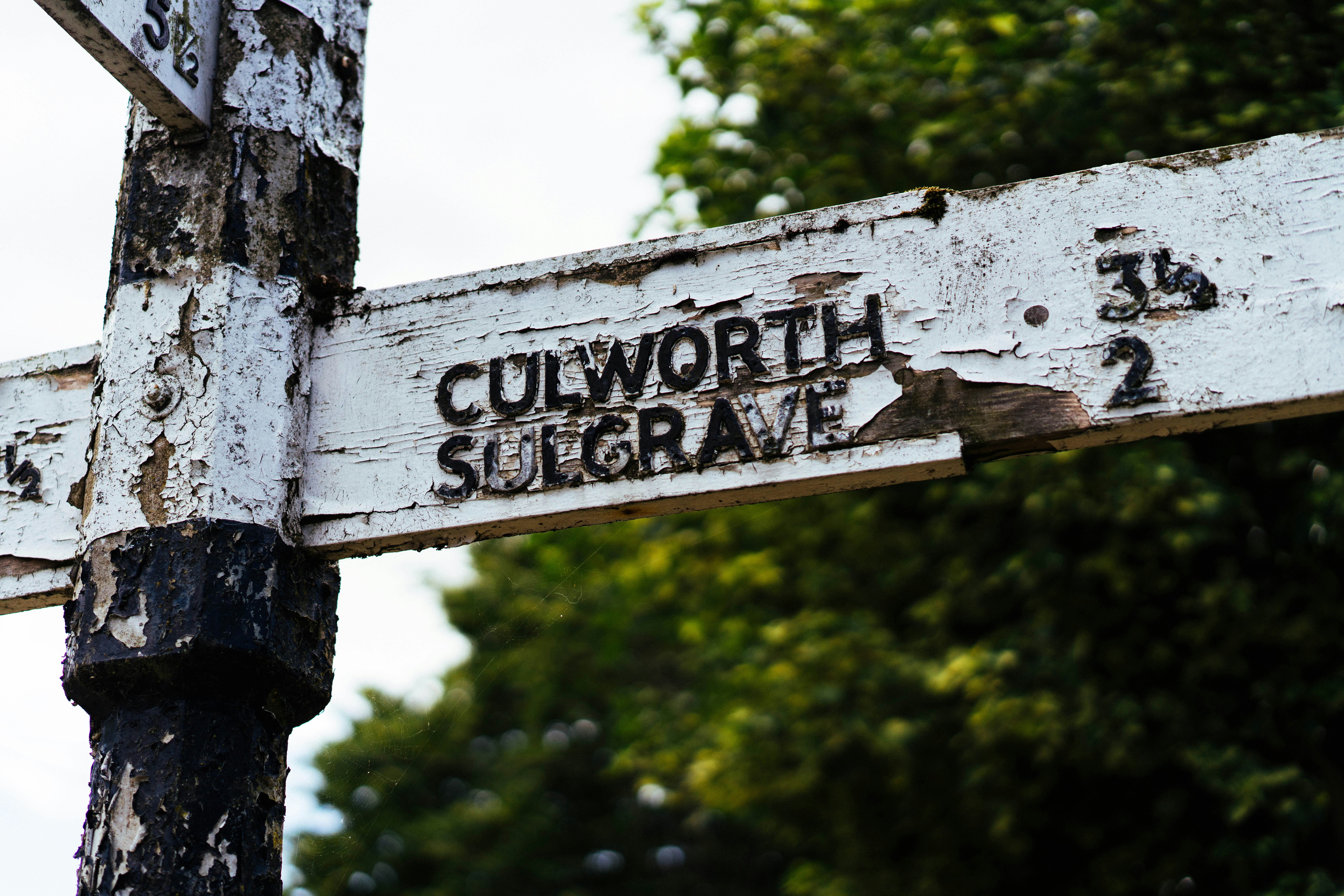 An old weathered signpost pointing to culworth and sulgrave.