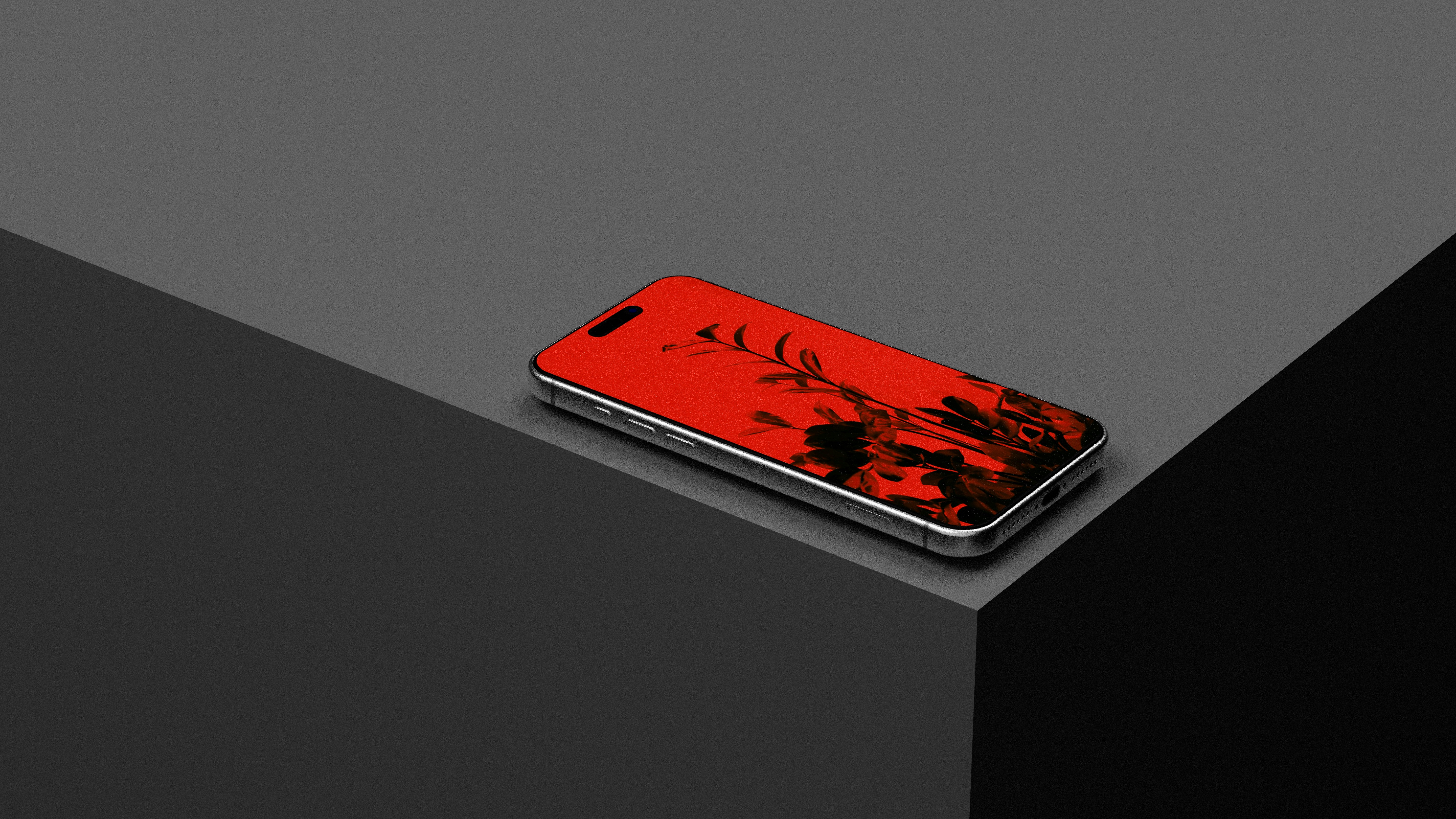 Smartphone with red and black abstract screen on gray platform.