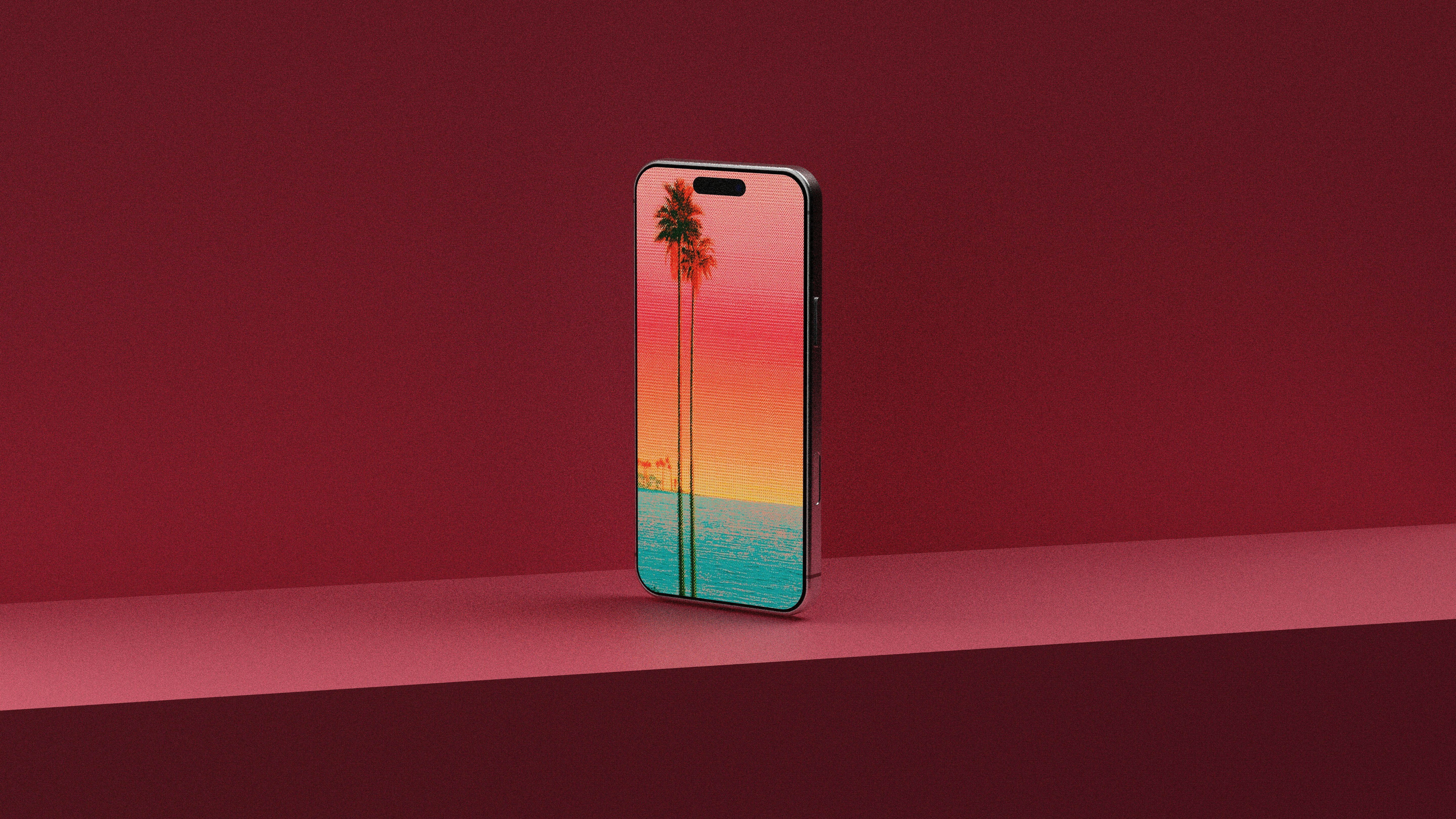 Smartphone with colorful palm tree wallpaper on a red shelf.