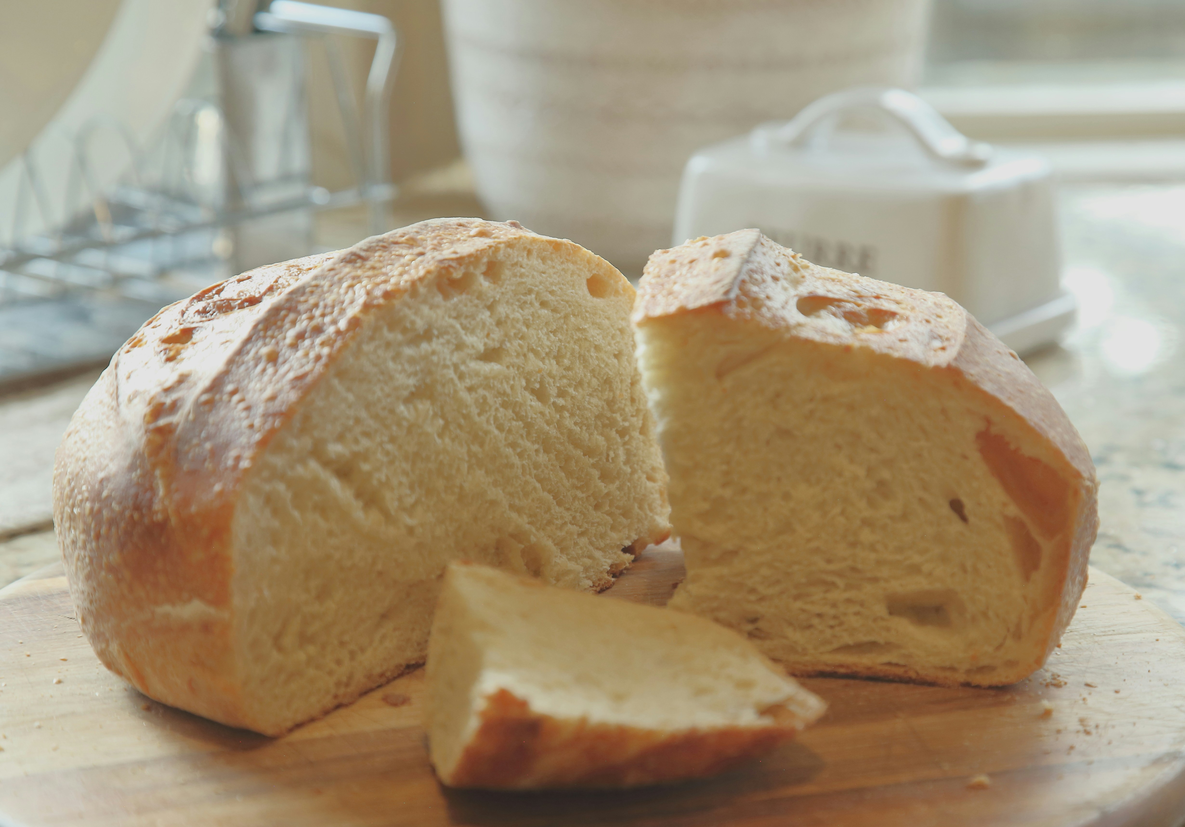 Delicious homemade bread loaf, freshly sliced on a wooden board.
