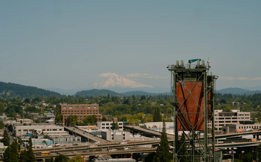 Portland cityscape with a bridge tower and a distant snow-capped mountain