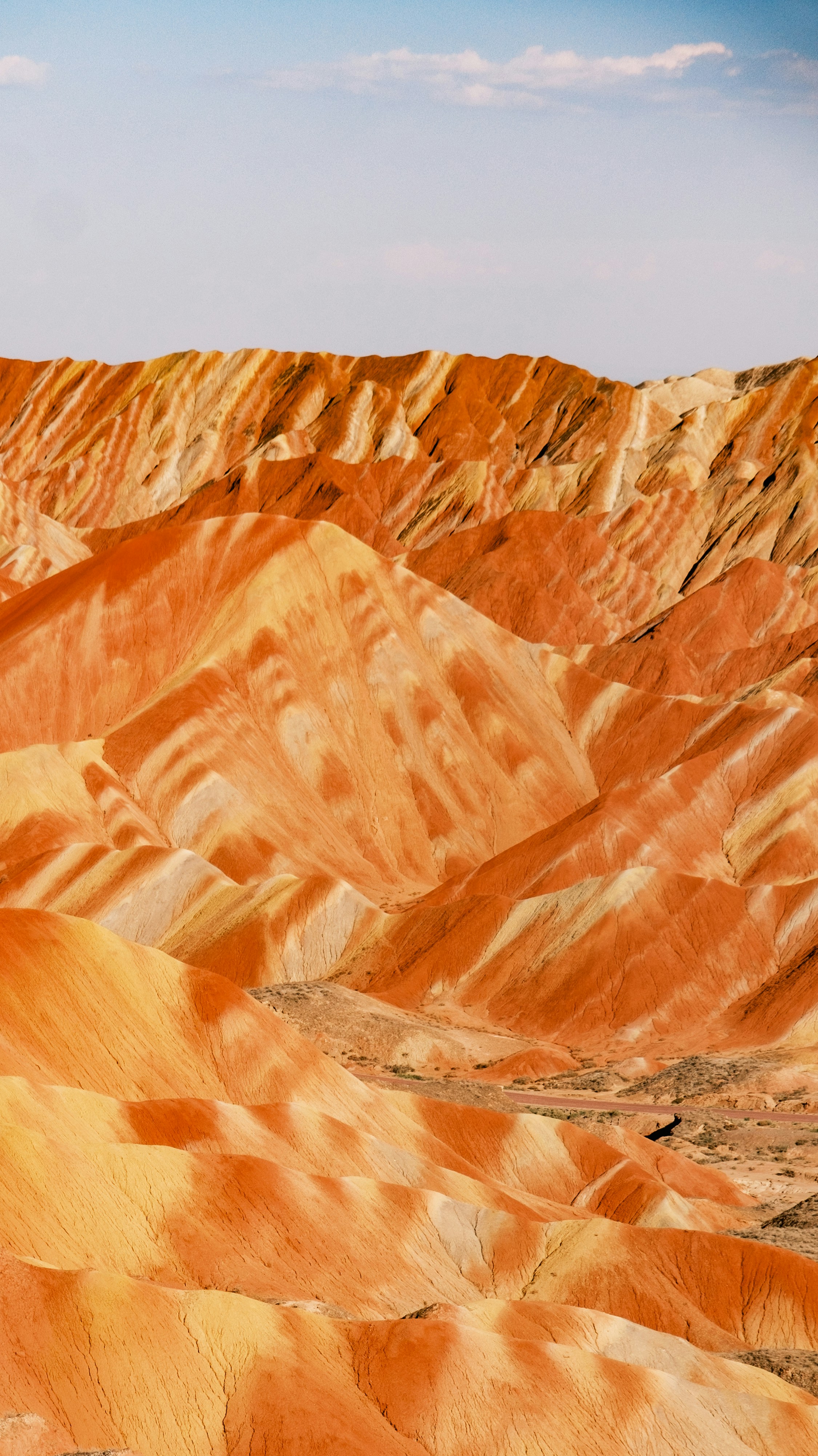 Vibrant layered mountains under a clear sky.