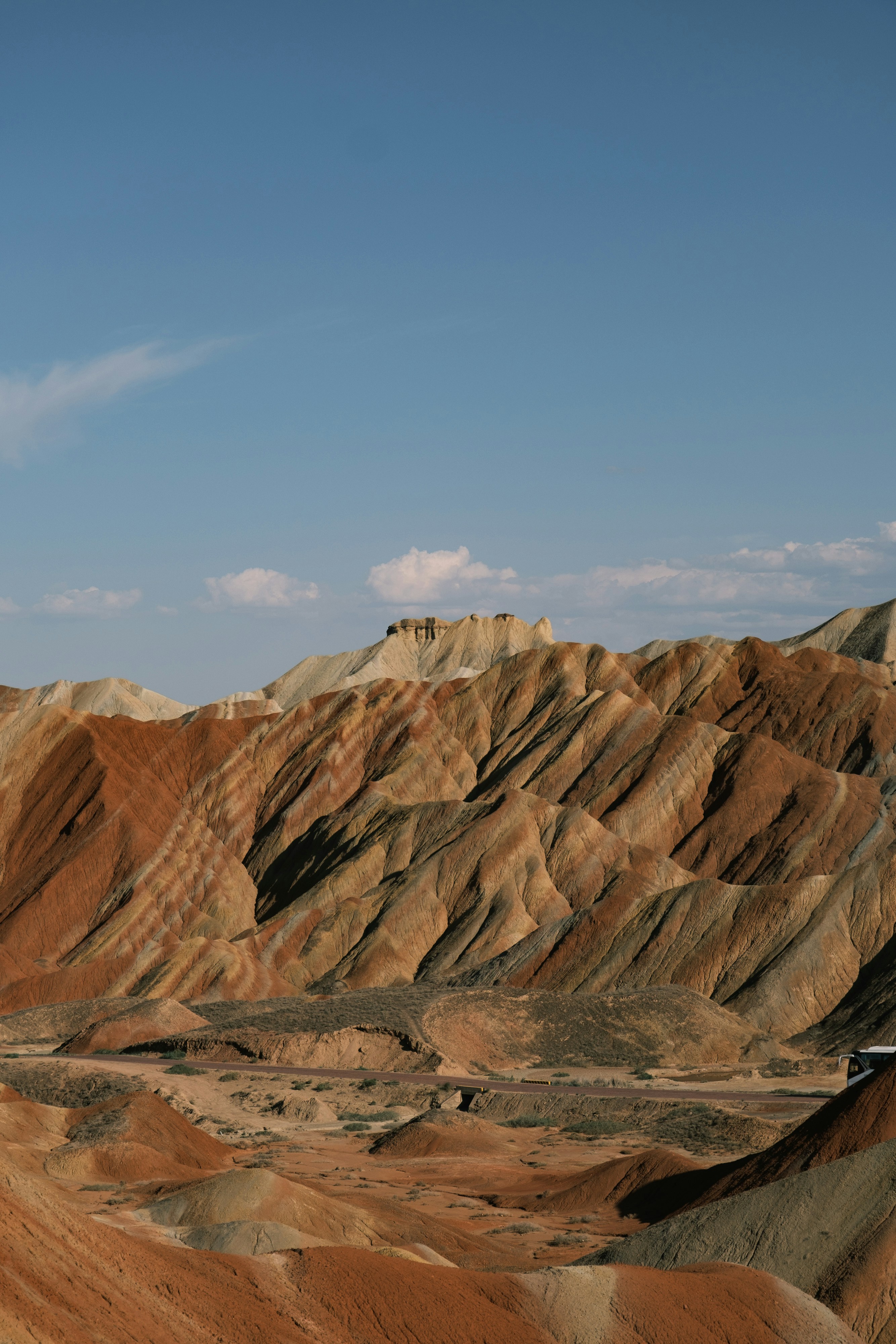 Vibrant striped mountains under a clear blue sky.