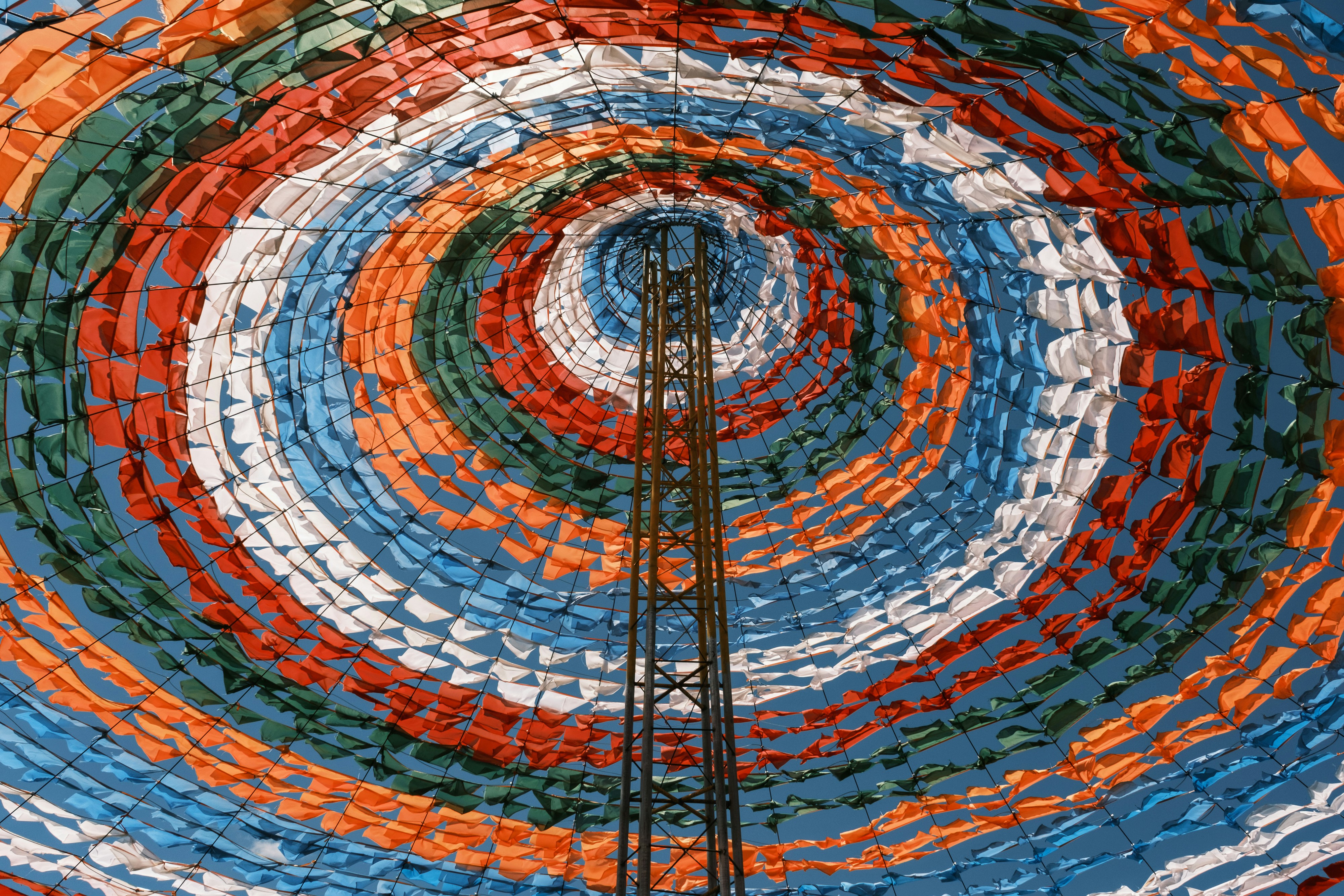 A central tower surrounded by colorful, concentric fabric circles.
