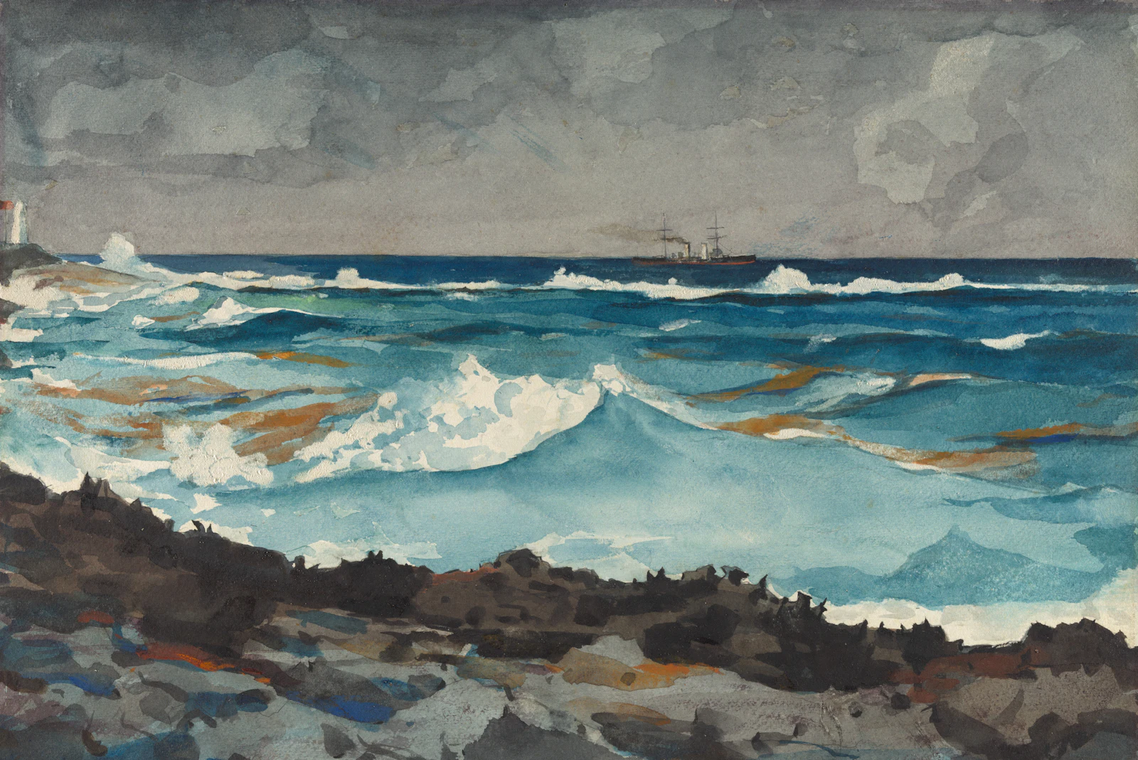 Turquoise surf breaking against dark rocks under a heavy grey sky.
