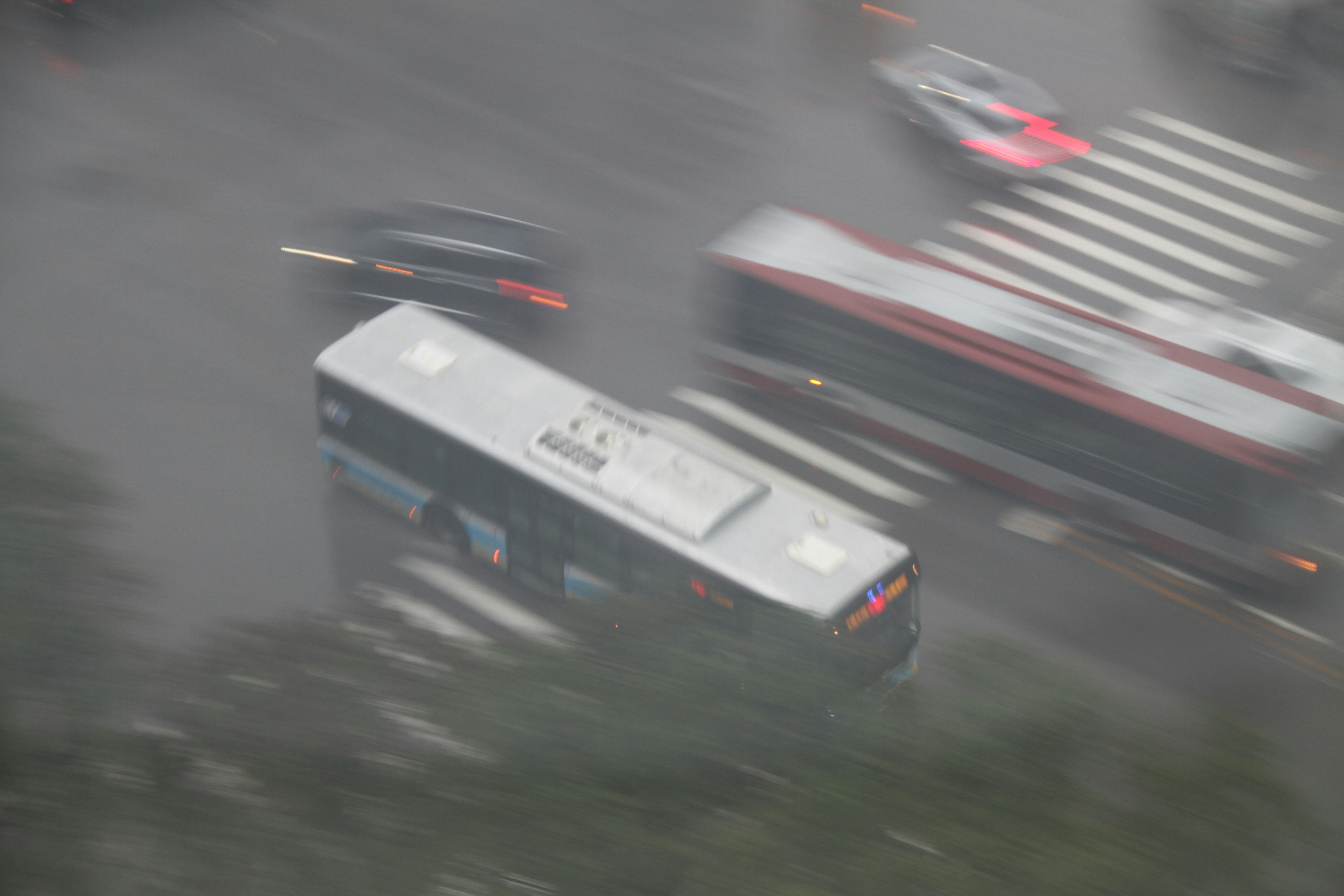 Buses and cars with motion blur on a city road