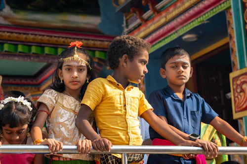 Family visiting a colourful Hindu temple in India