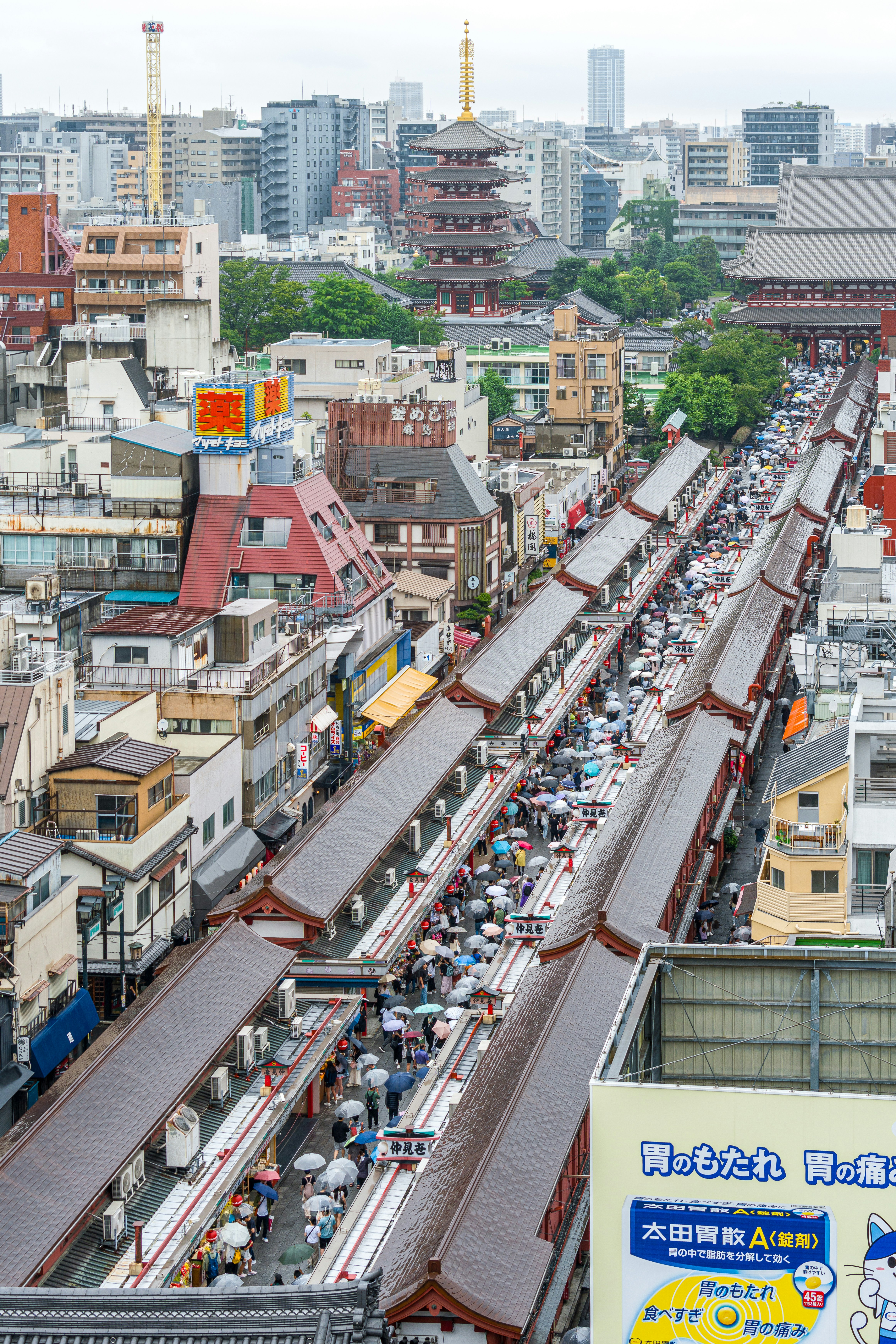 Overhead view of a bustling market street and pagoda.