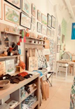 A cozy shop interior with handmade goods and framed artwork