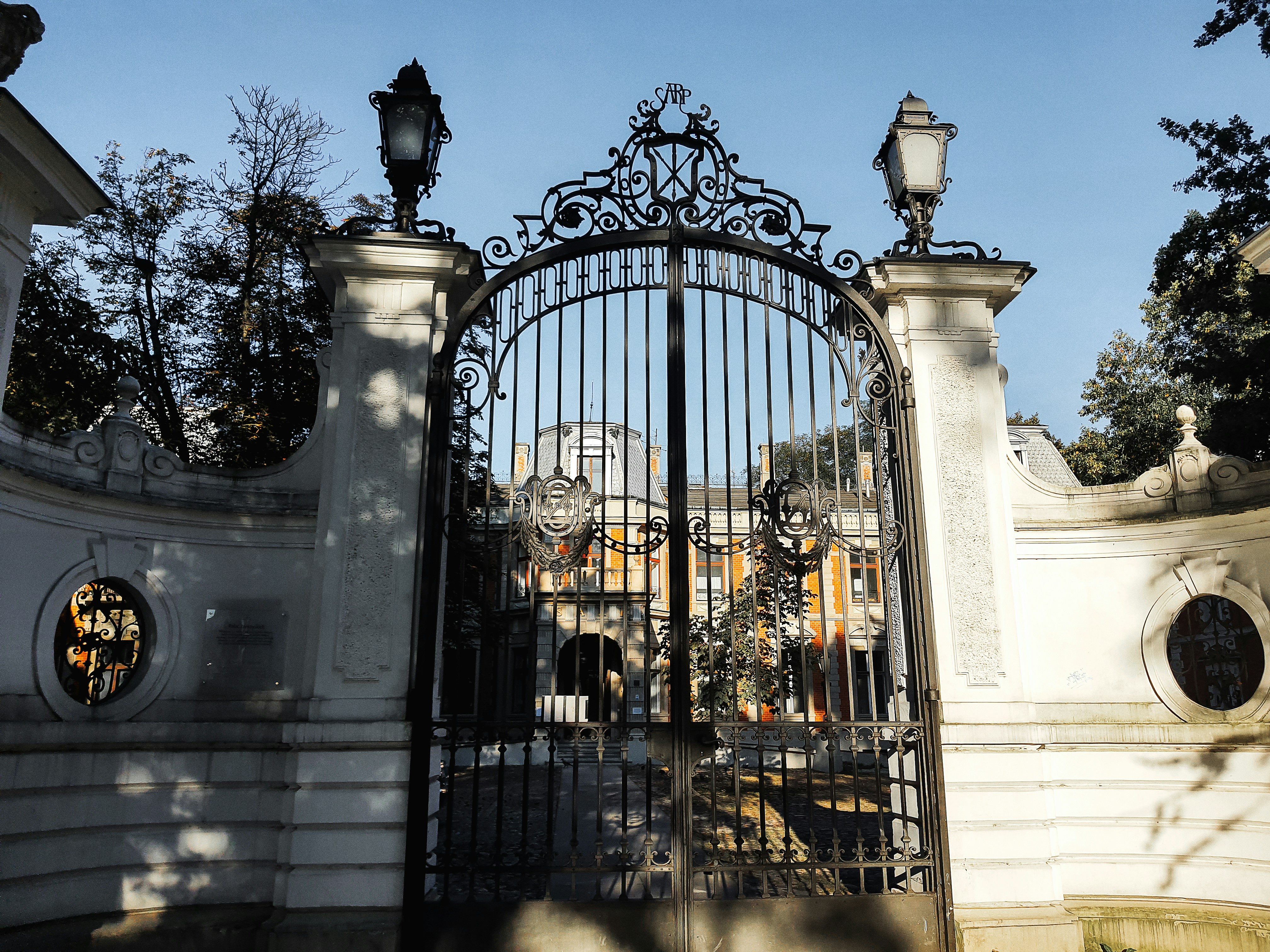 A magnificent wrought-iron gate and stone pillars leading to a luxury Mediterranean villa in the Silverwood neighborhood of Granite Bay.
