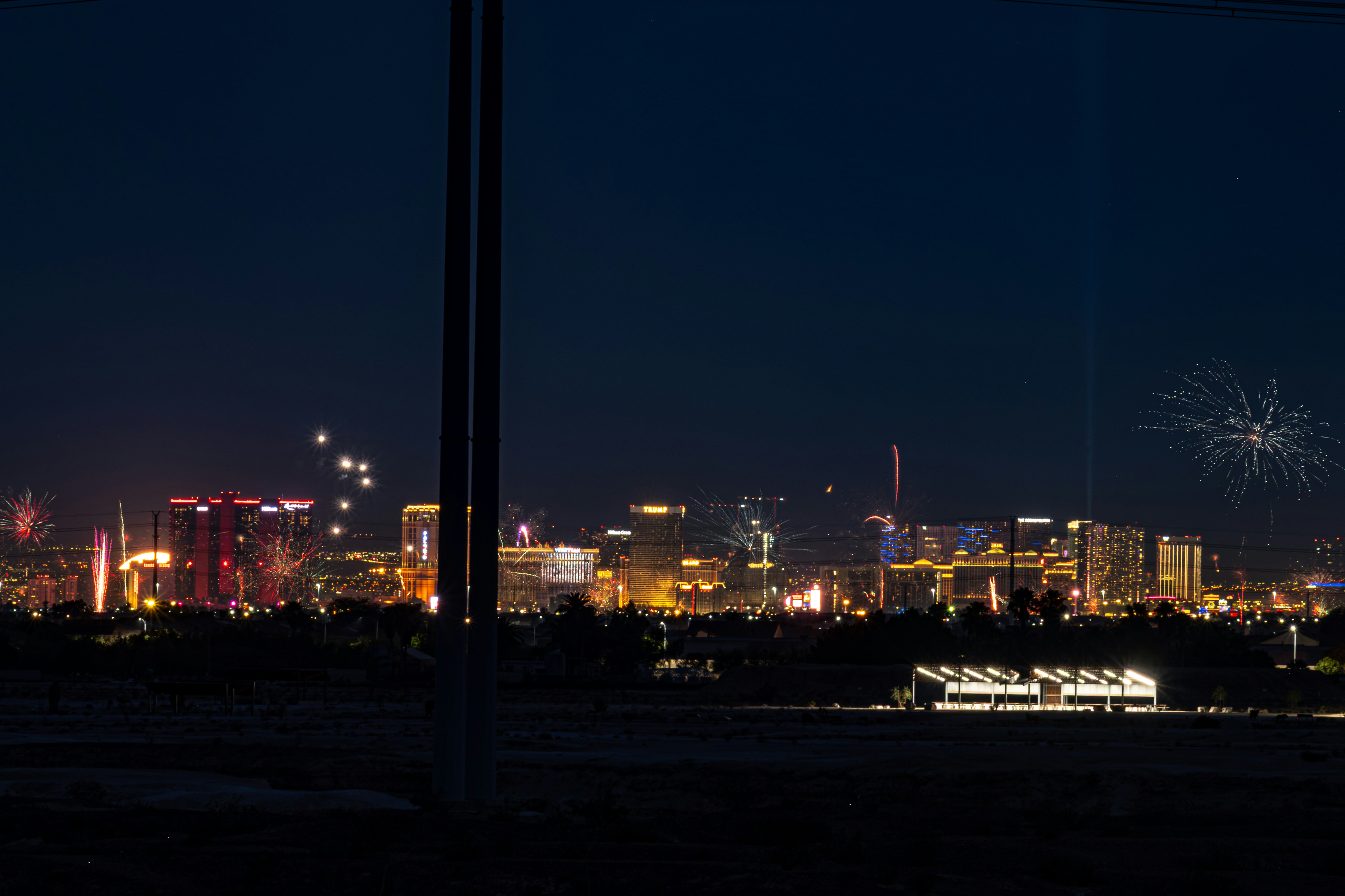 La silhouette de la ville illuminée la nuit par de nombreux feux d’artifice.