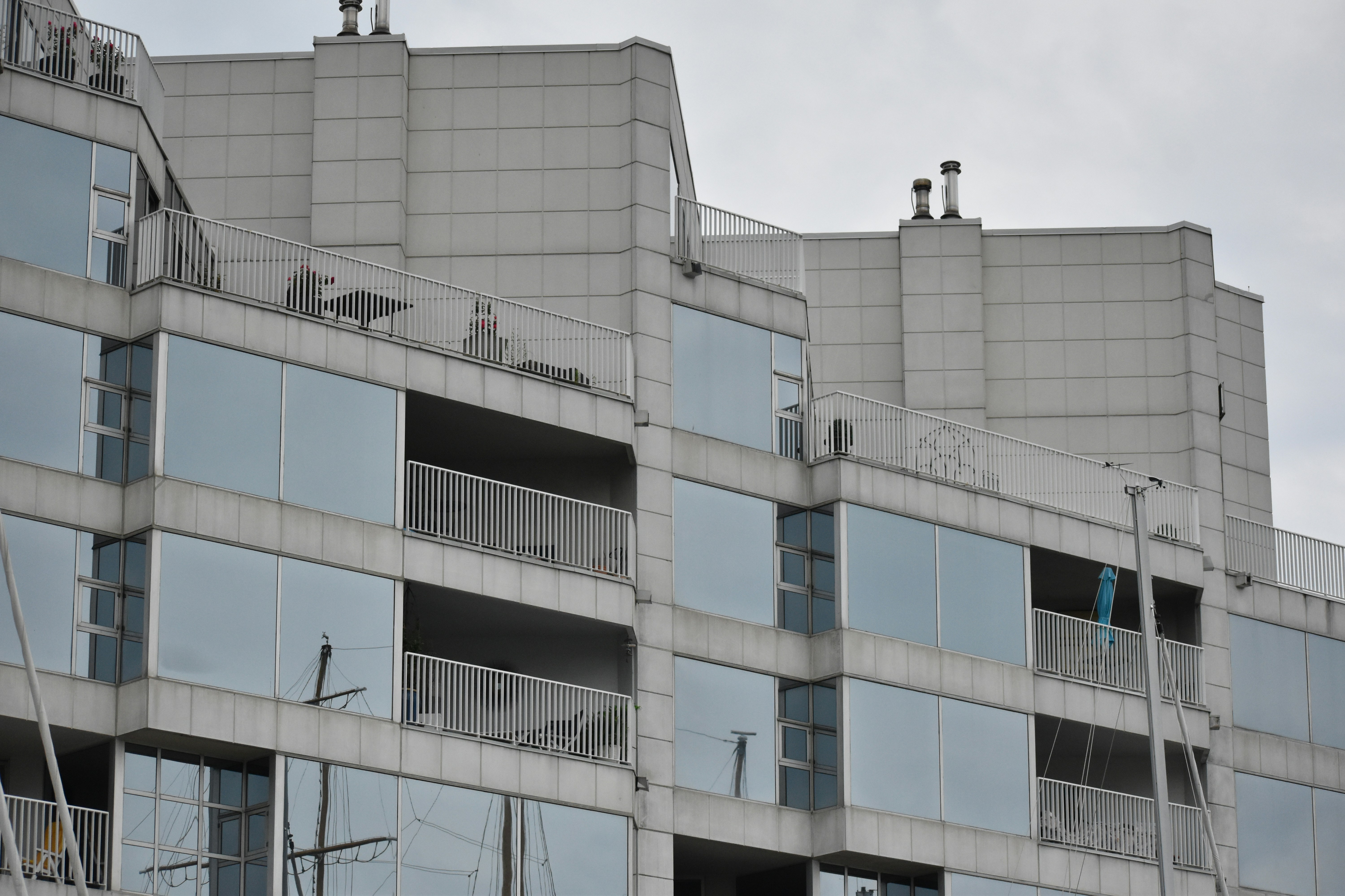 Modern building facade with reflective windows and balconies.