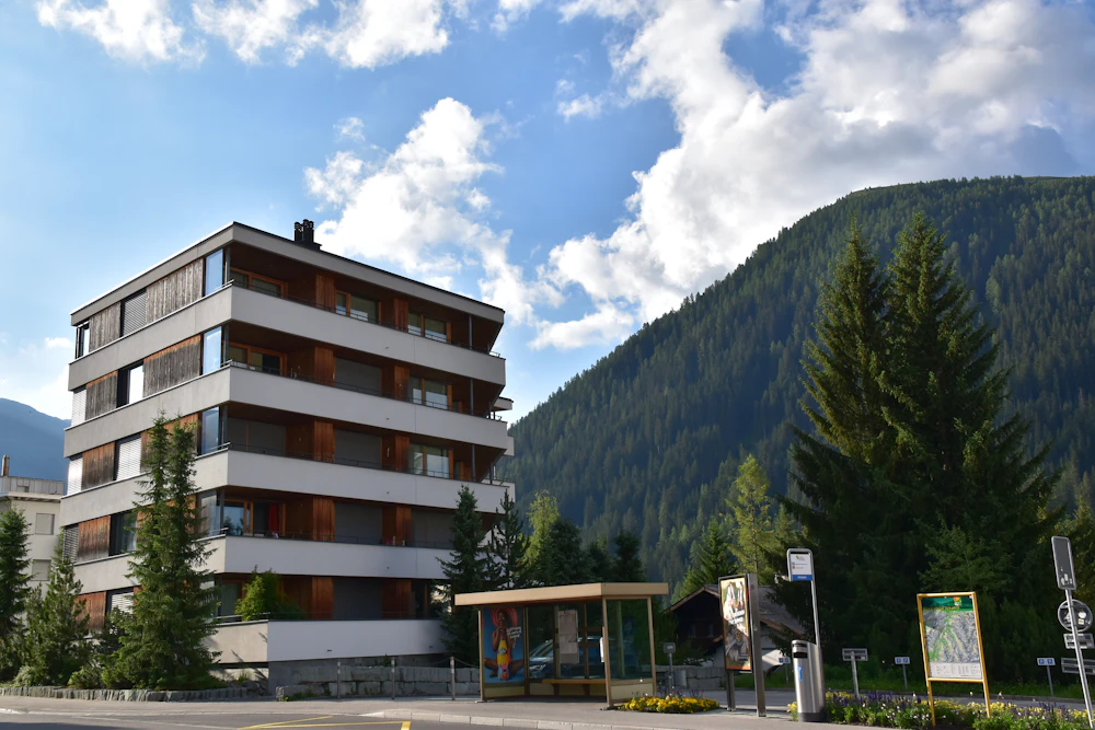 Mehrfamilienhaus vor Bergkulisse