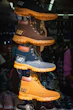 Stacked cat boots in various colors on display
