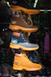 Stacked cat boots in various colors on display