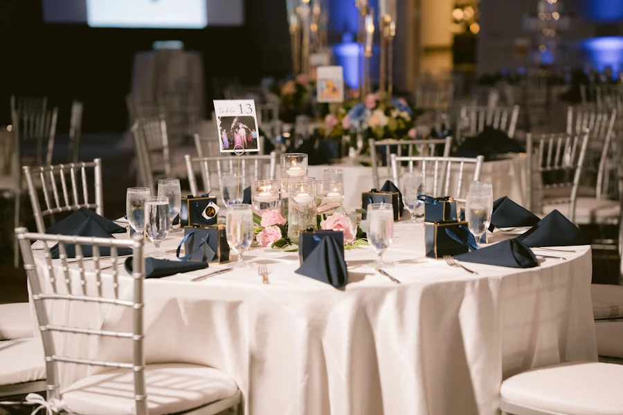 An event table with white linen and a floral centrepiece