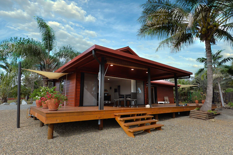 Timber house with a raised deck among palm trees