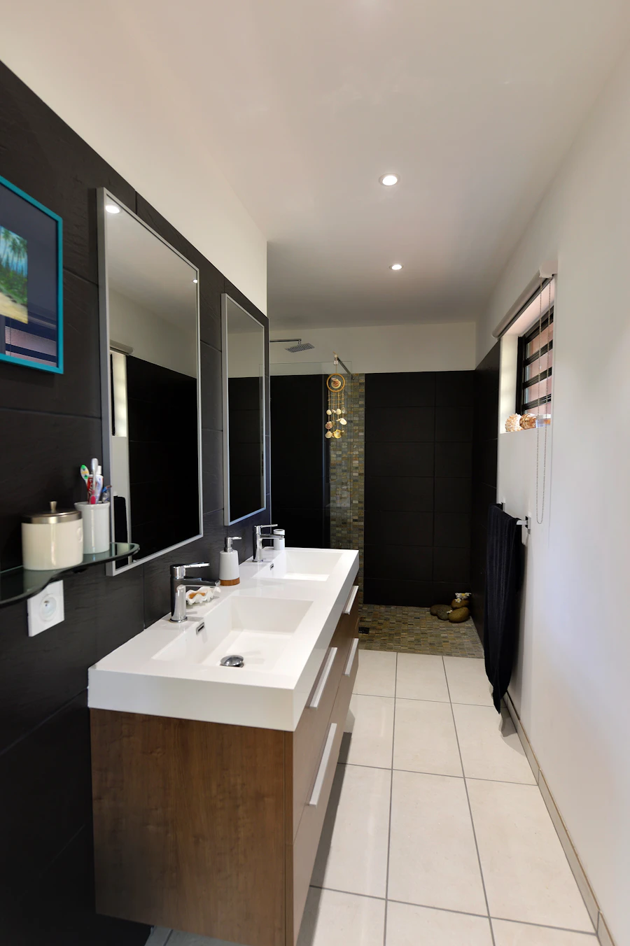 Bathroom with dark tile double vanity and walk-in shower