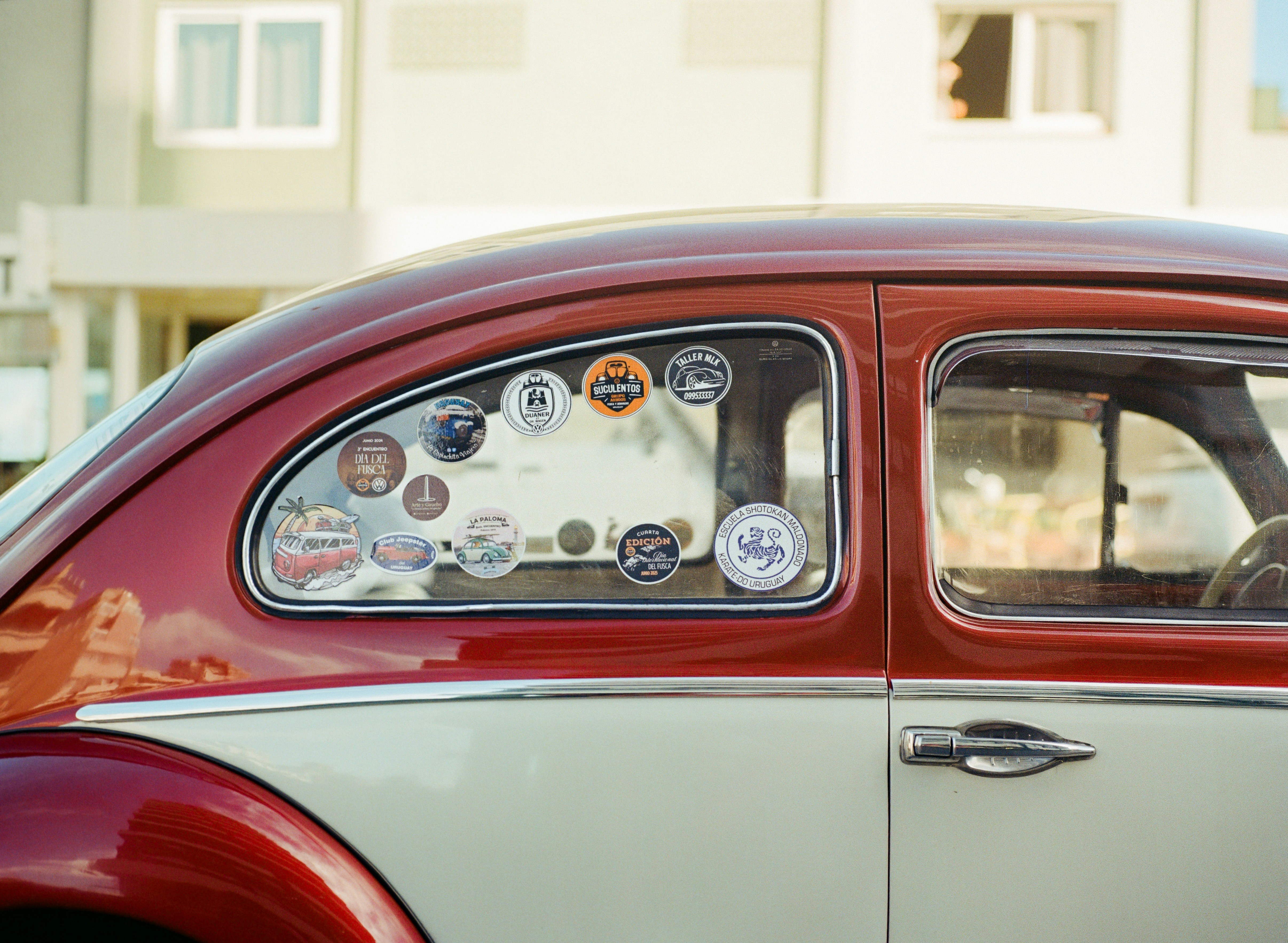 Cars Close Up Of A Two Tone Red And Cream Vintage Volkswagen Beetle, Its Rear Window Covered With Vintage Club And Travel Stickers. Film Photography With Soft Warm Color. 4K Wallpaper #2695