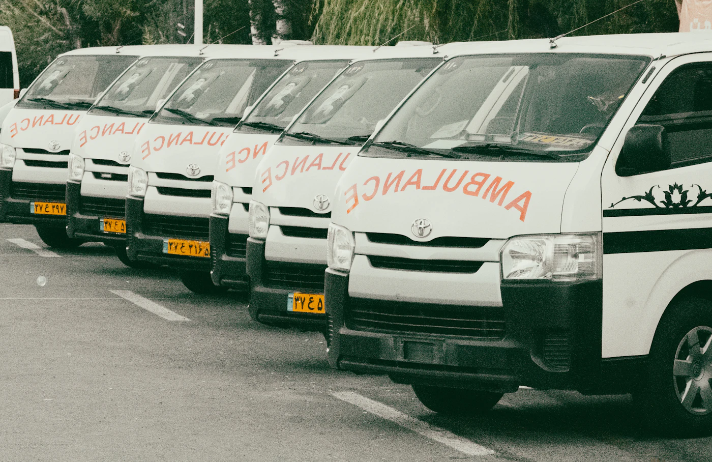 A line of ambulances parked nose-out and ready for assignment