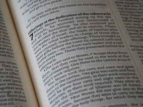 Pages of an open bible with visible scripture
