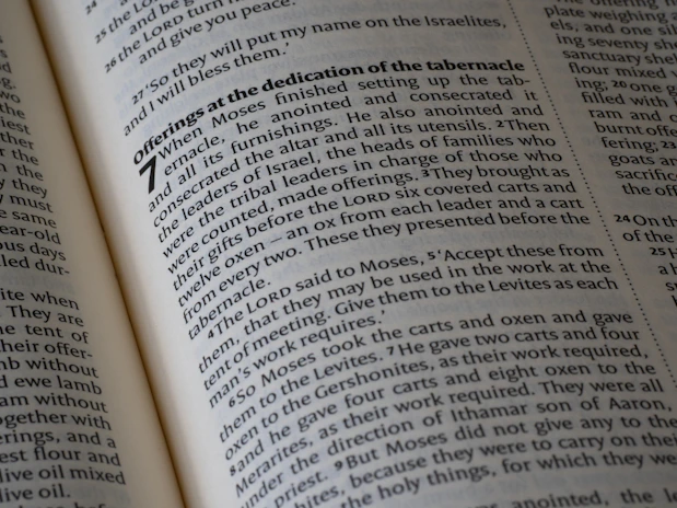Pages of an open bible with visible scripture