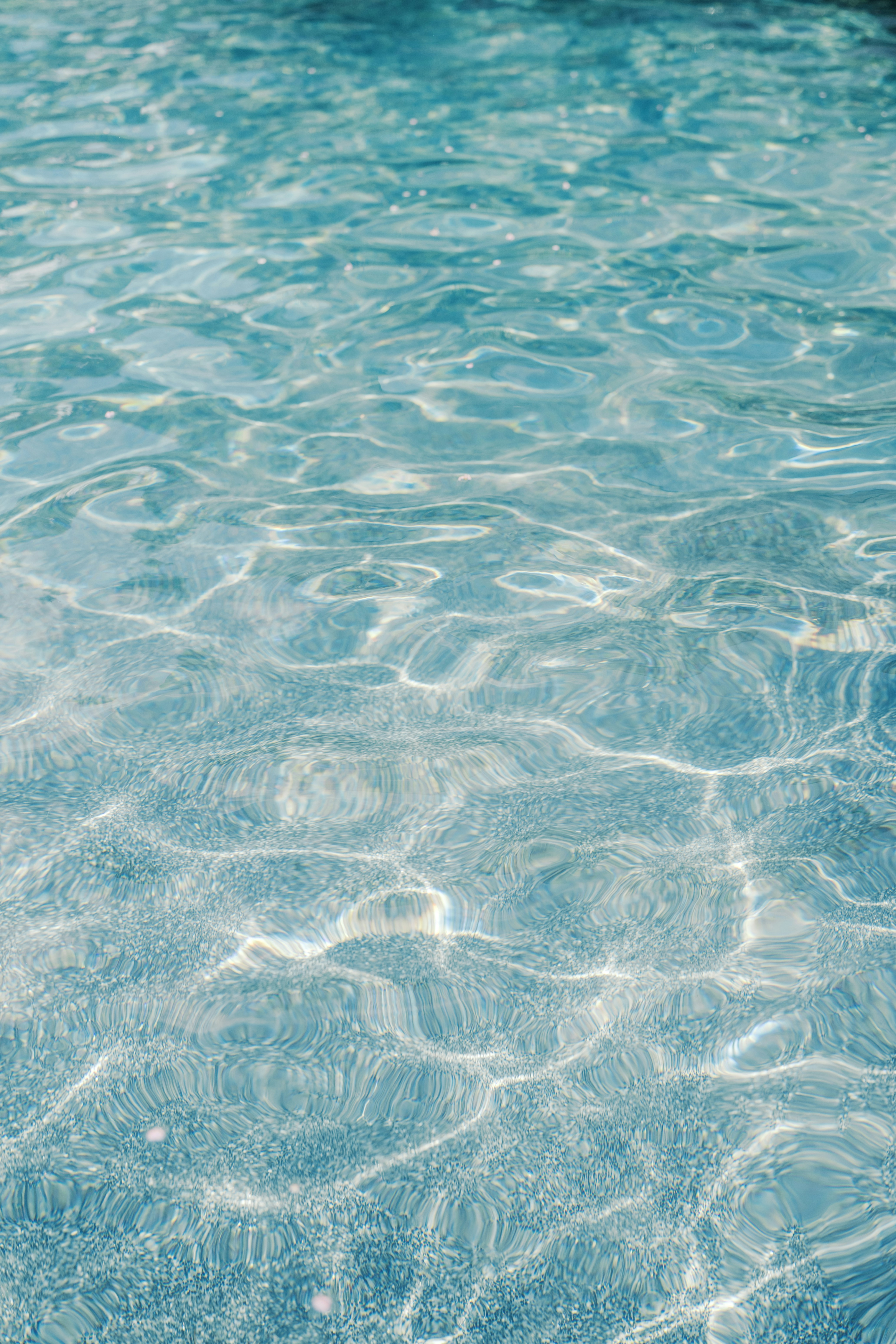 Clear blue water with shimmering sunlight reflections