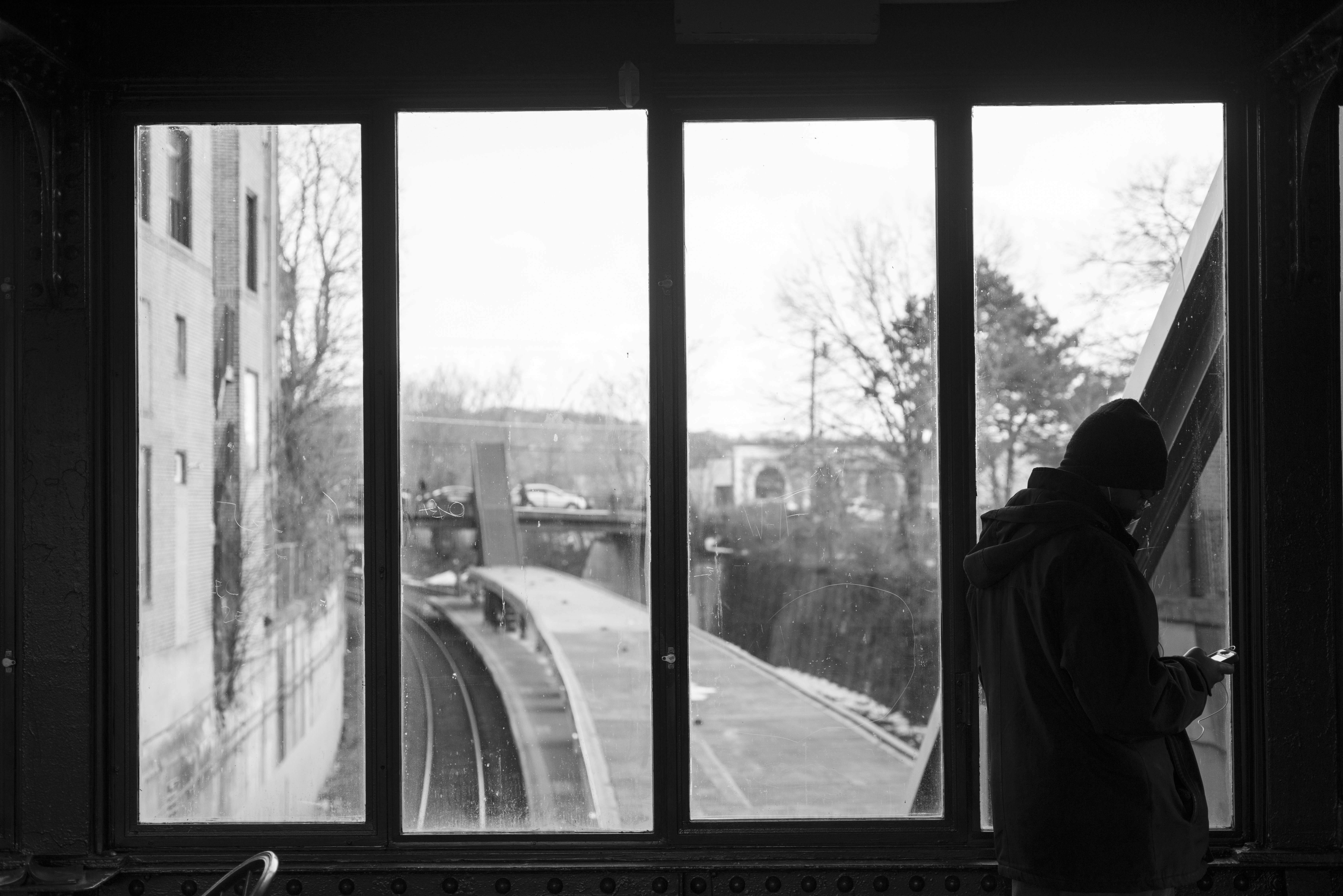 Technology Silhouetted Person By Windows Overlooking Train Tracks And City. 4K Wallpaper #2918
