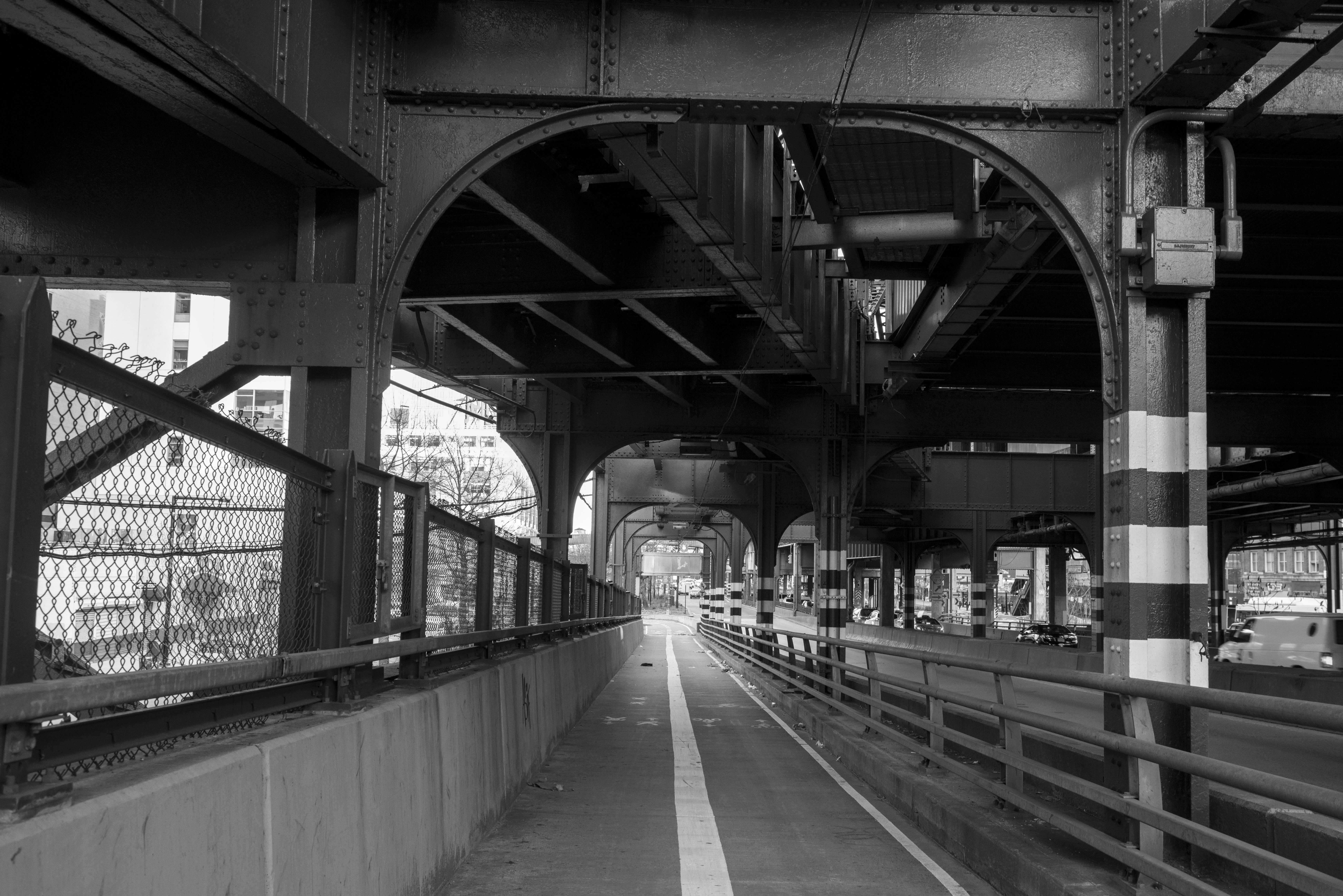 Pathway beneath a large, elevated urban bridge in monochrome - Free ...