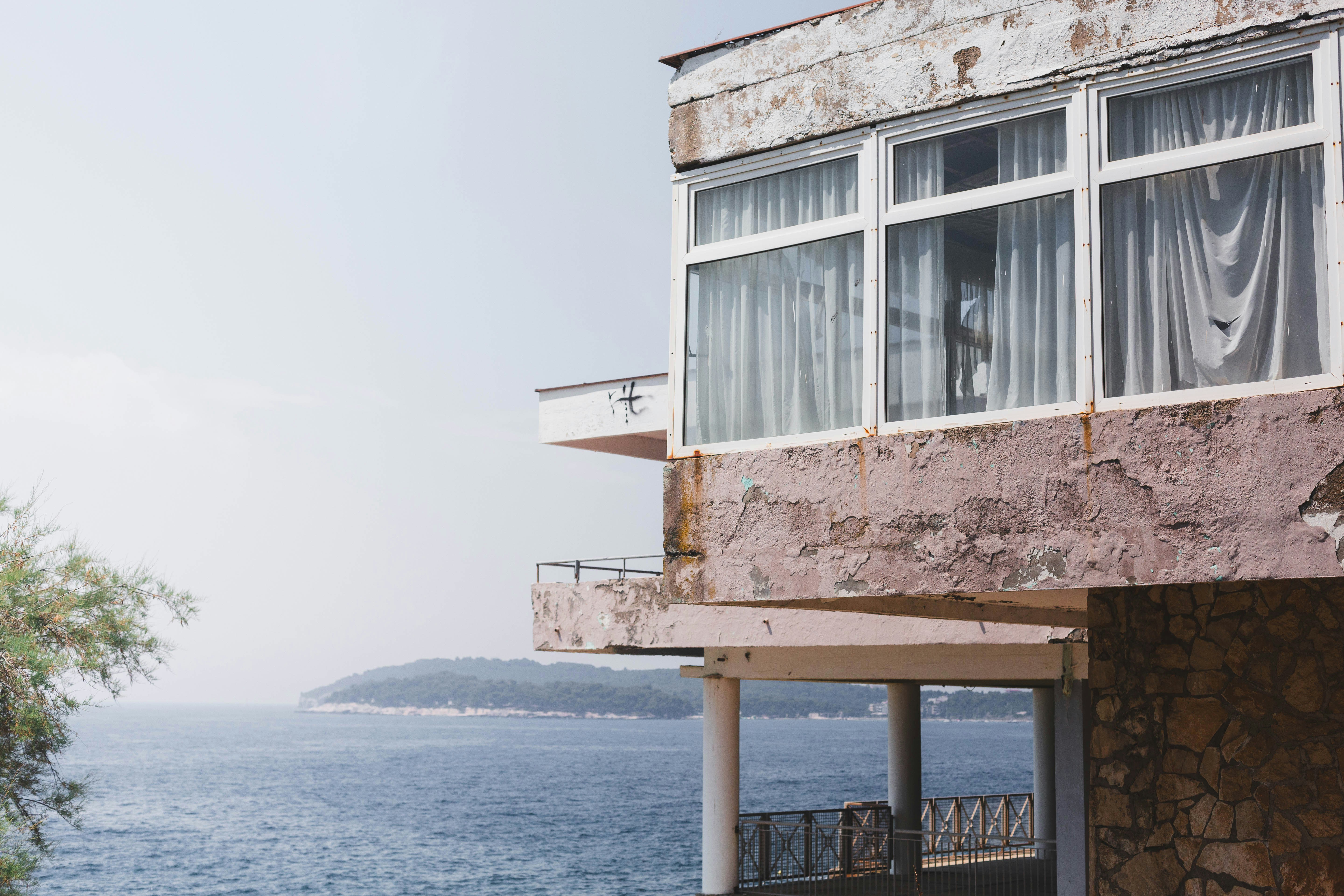 Weathered building with balconies overlooking the ocean