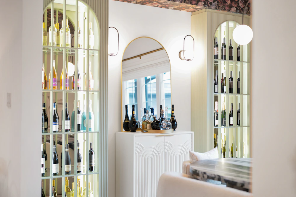 Elegant wine bar interior with arched wine displays and warm lighting