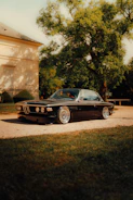 A sleek black vintage car parked outdoors
