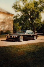 A sleek black vintage car parked outdoors