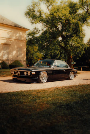 A sleek black vintage car parked outdoors