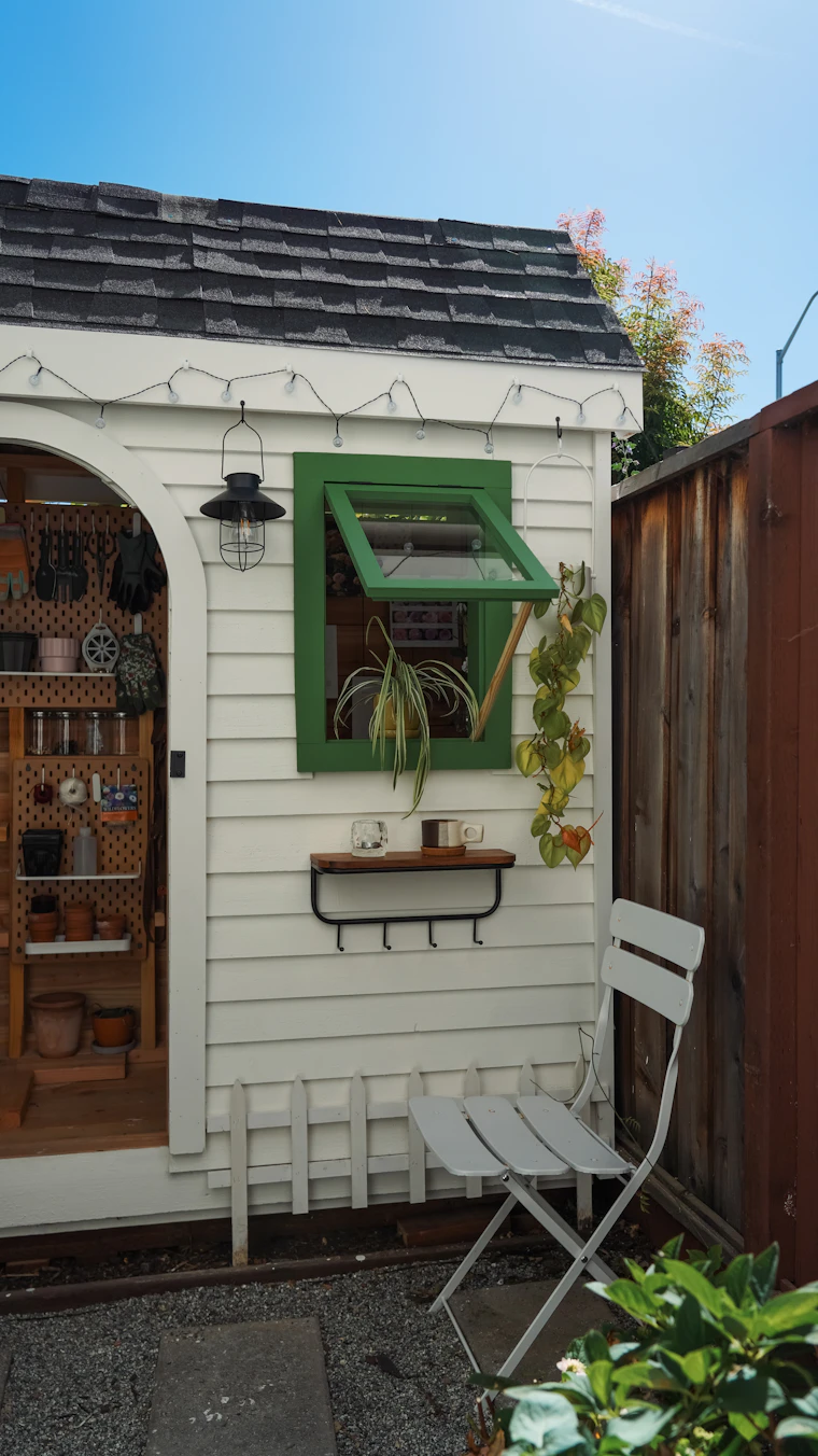 Backyard studio with a green framed window