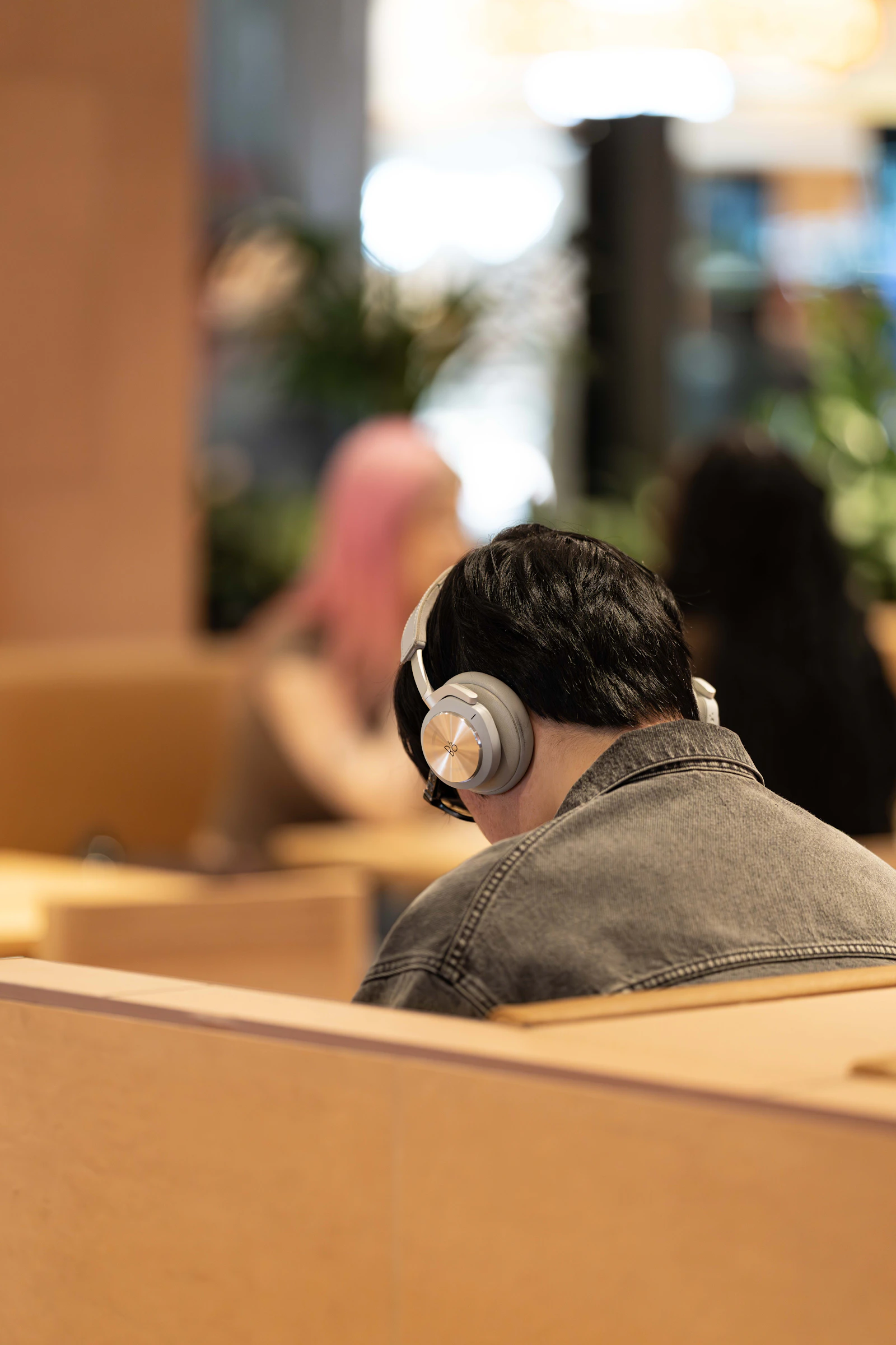 Person wearing wireless headphones in a modern everyday environment