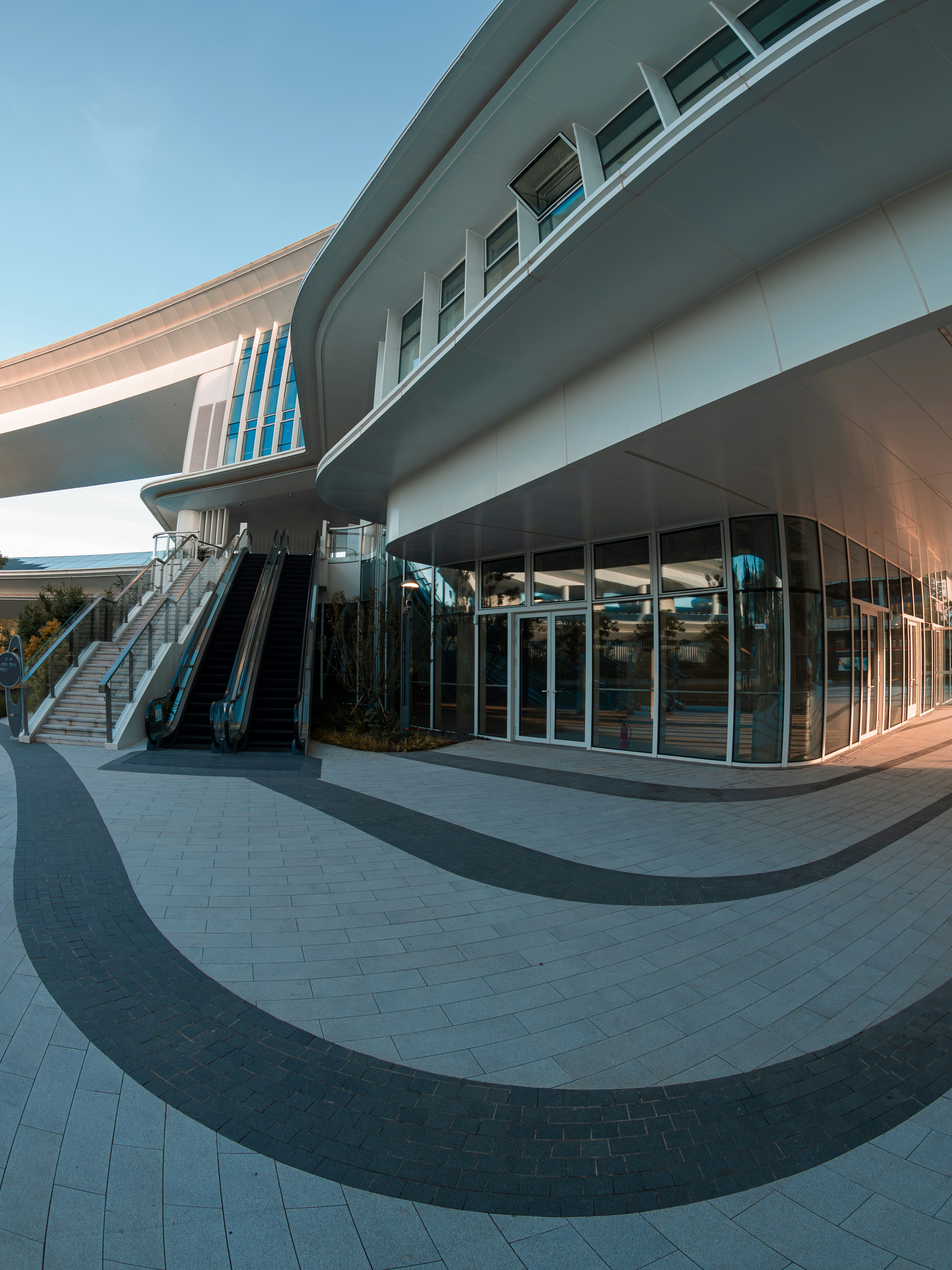 Modern building with escalator and curved architecture
