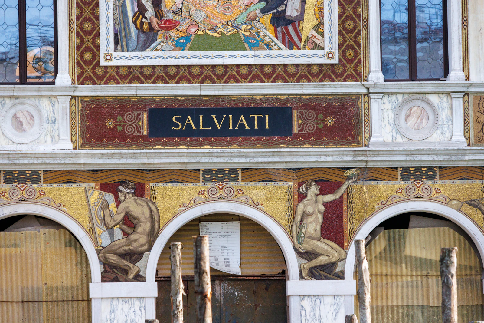 Gold mosaic panels and the Salviati name on a palazzo façade on the Grand Canal in Venice