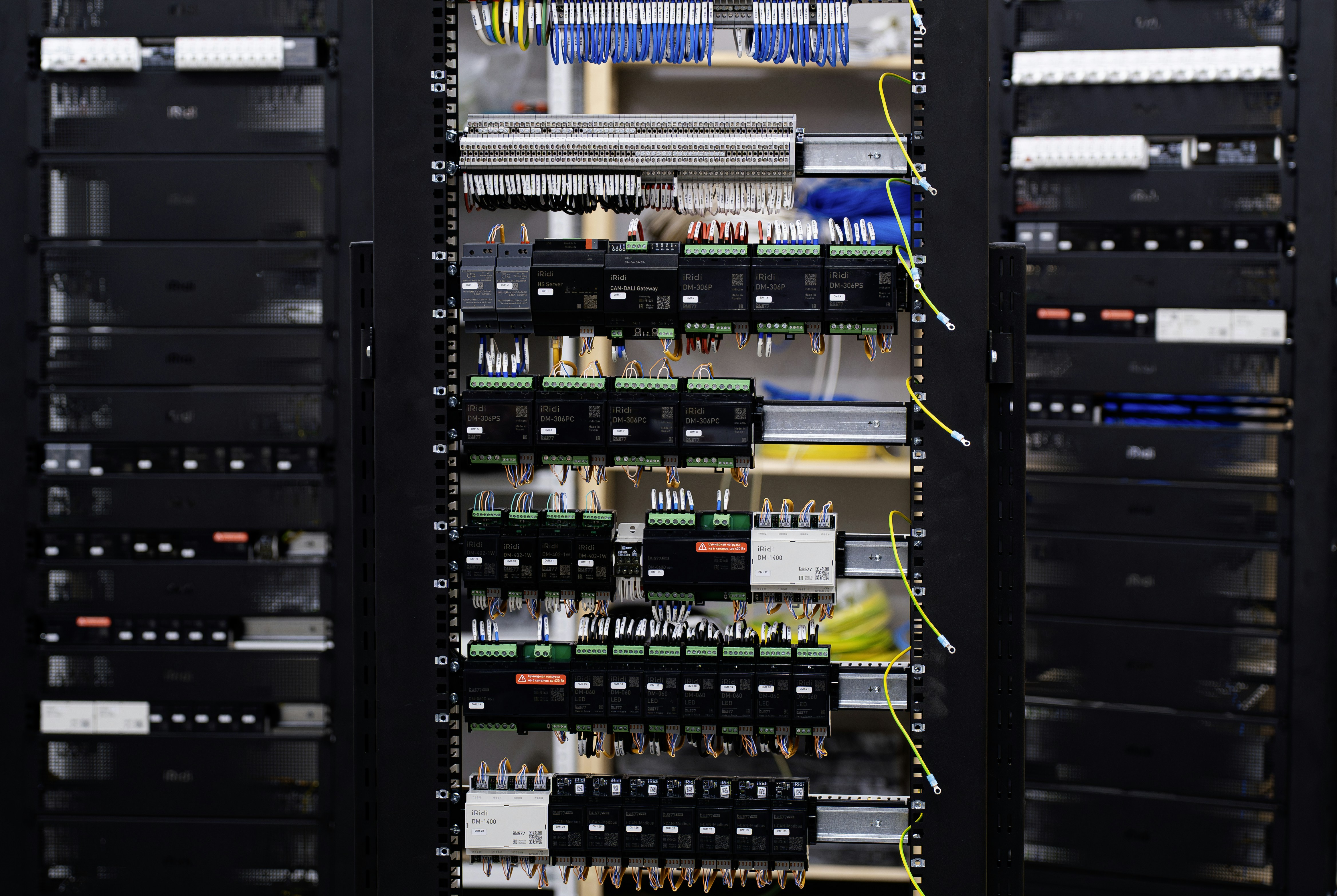 Open electrical control panel with wires and circuit breakers being installed