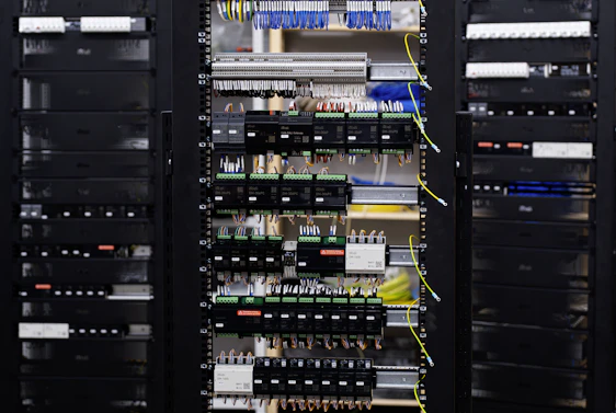 Open electrical control panel with wires and circuit breakers.